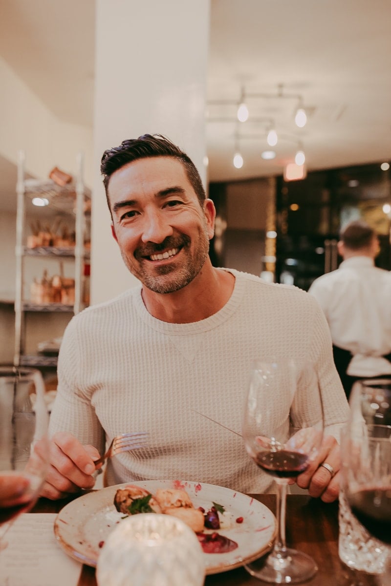 smiling man eating dinner