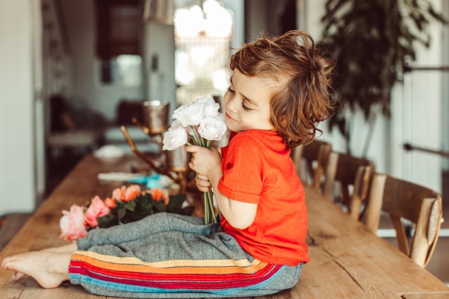 toddler holding flowers