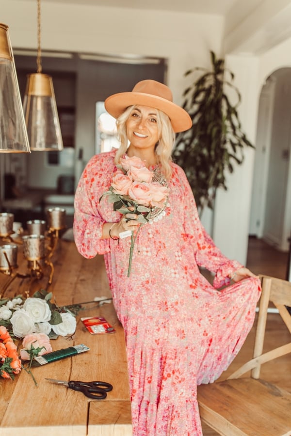 woman in dress holding flowers