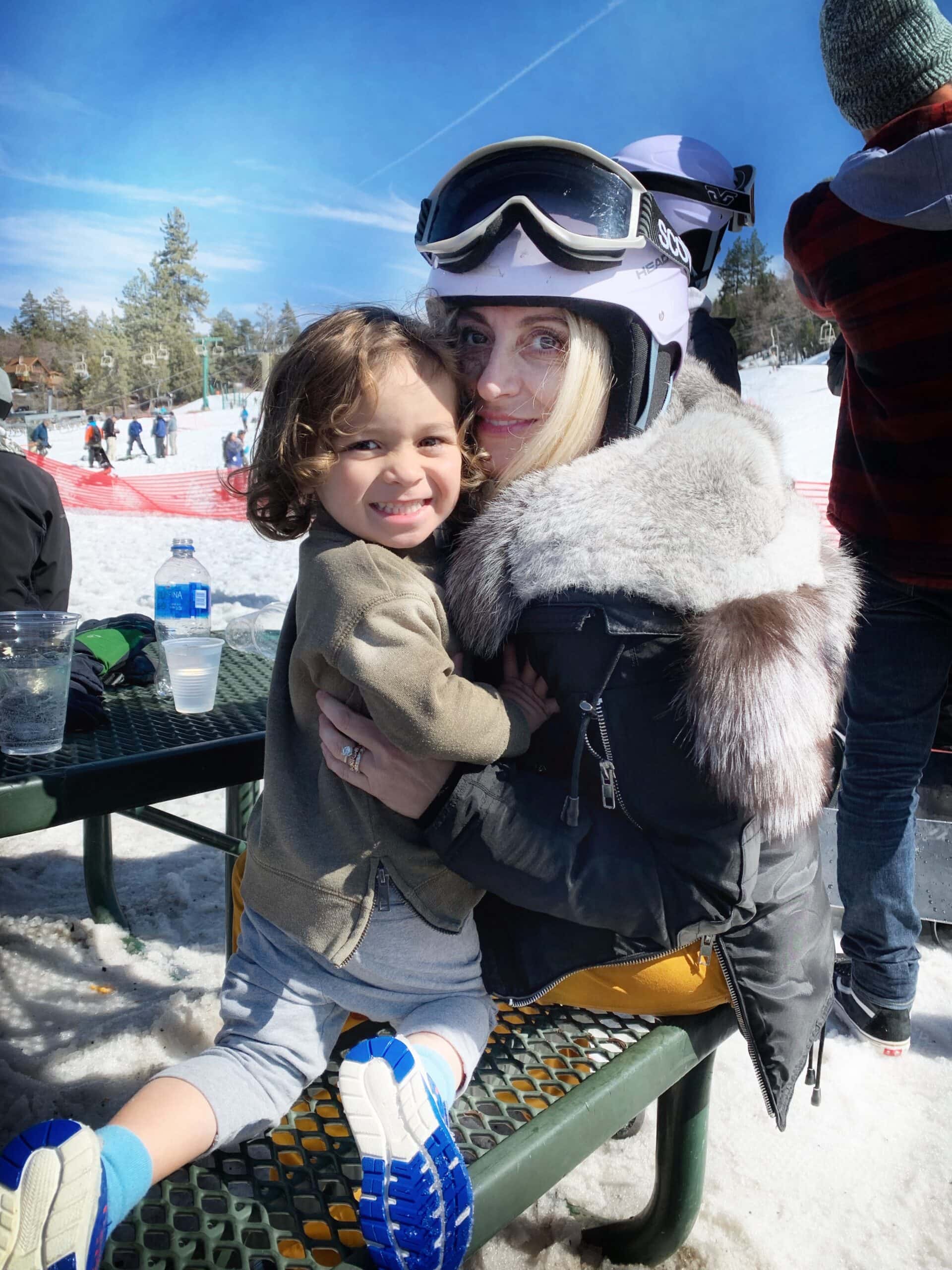 mom and baby hugging at ski resort