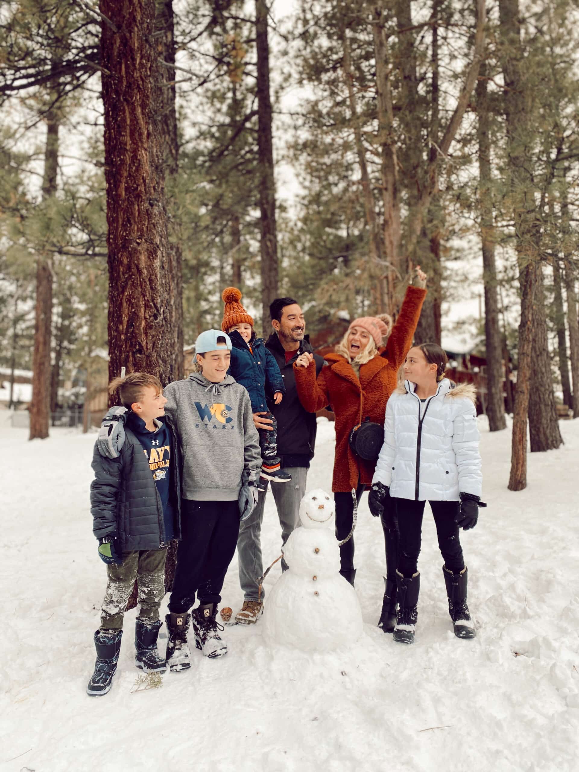 family playing in the snow