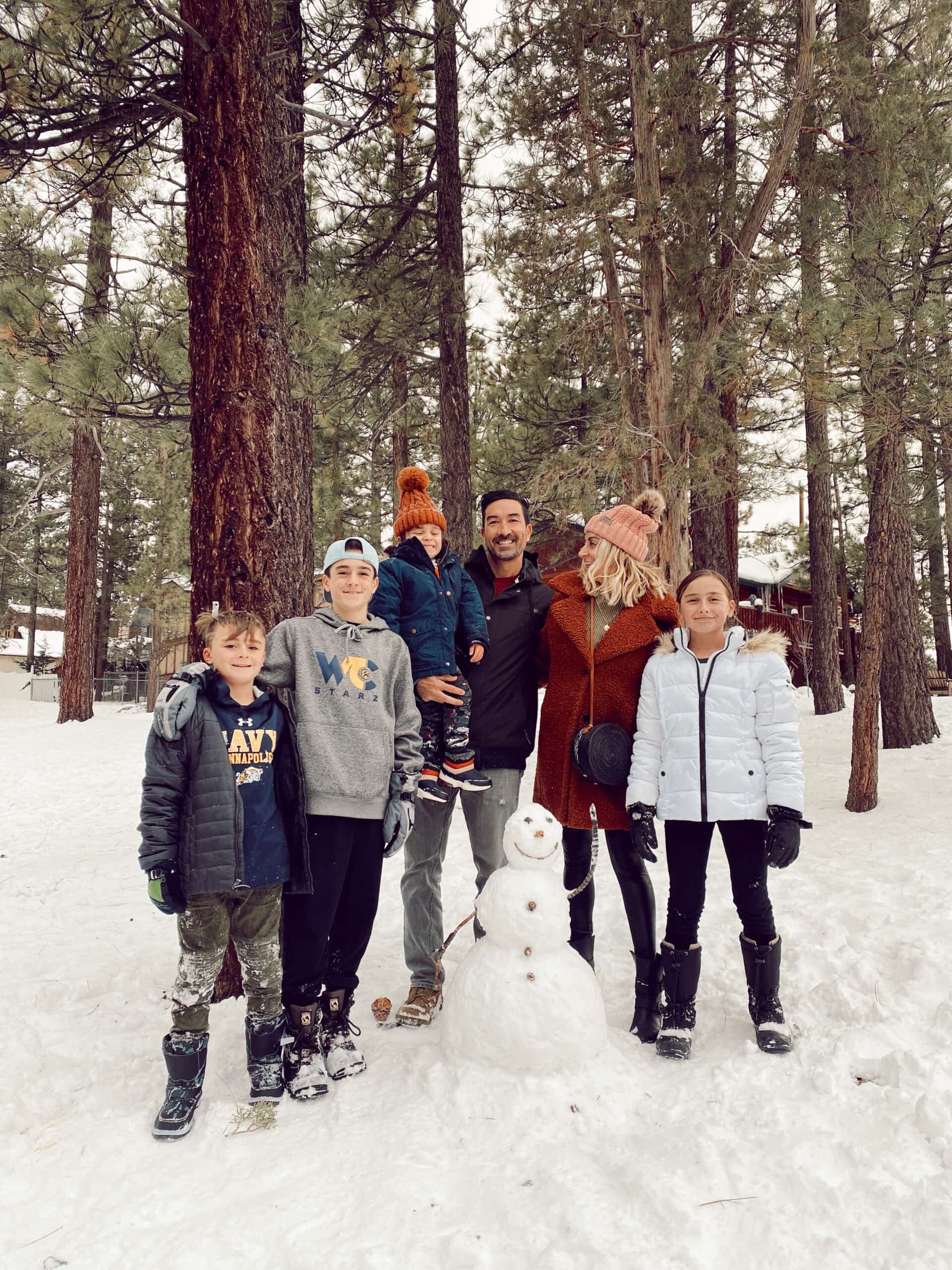 family building snowman in the forest