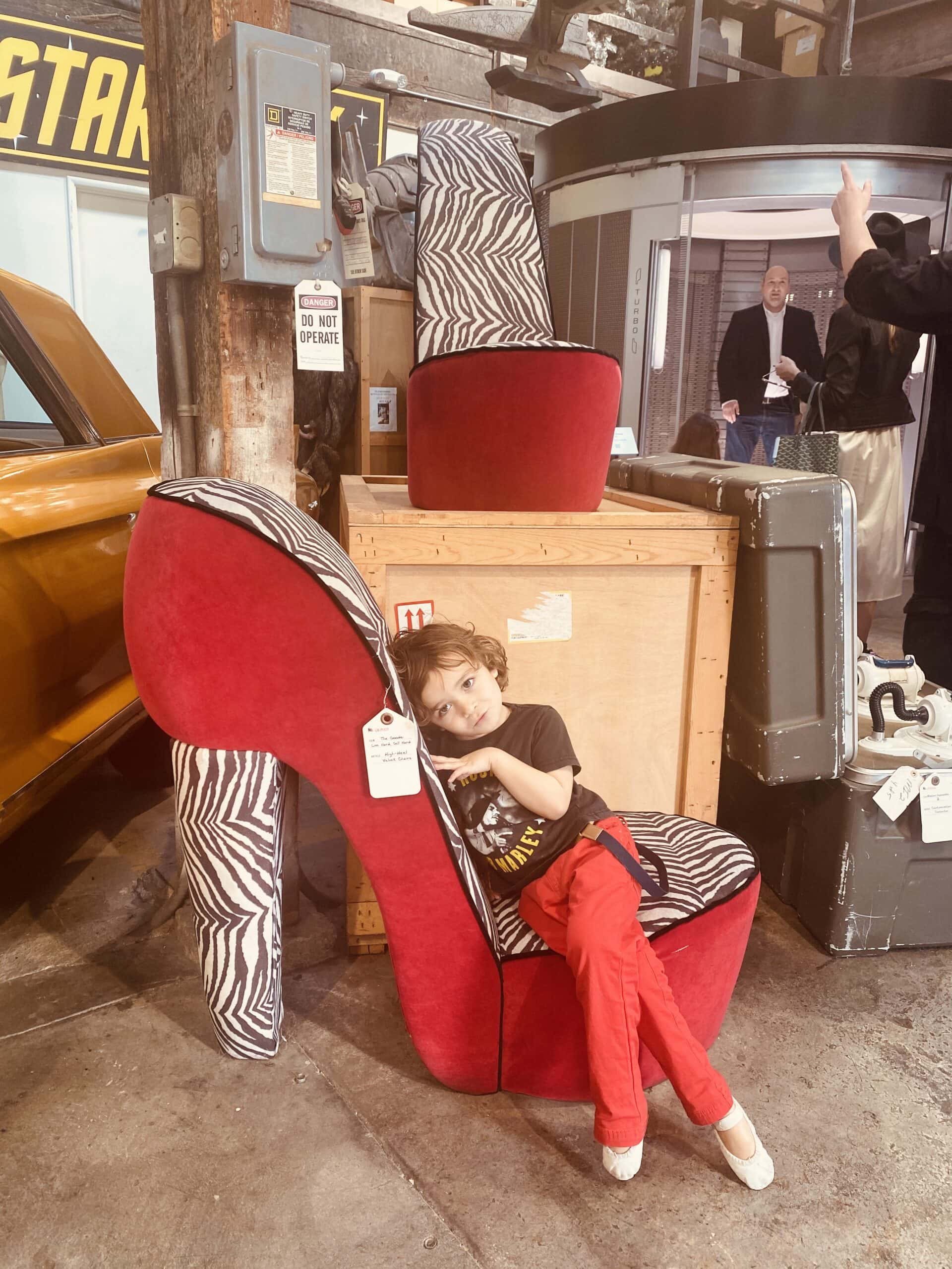 kid sitting on shoe chair