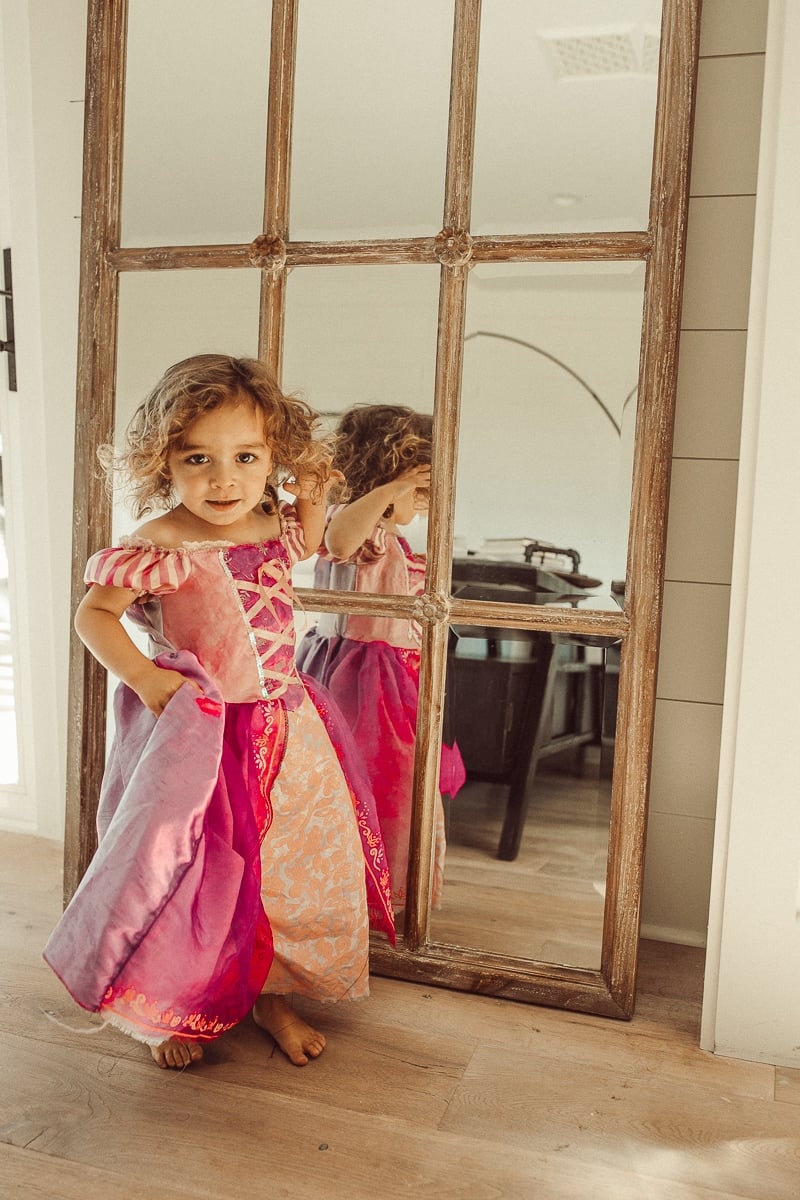 baby posing by mirror