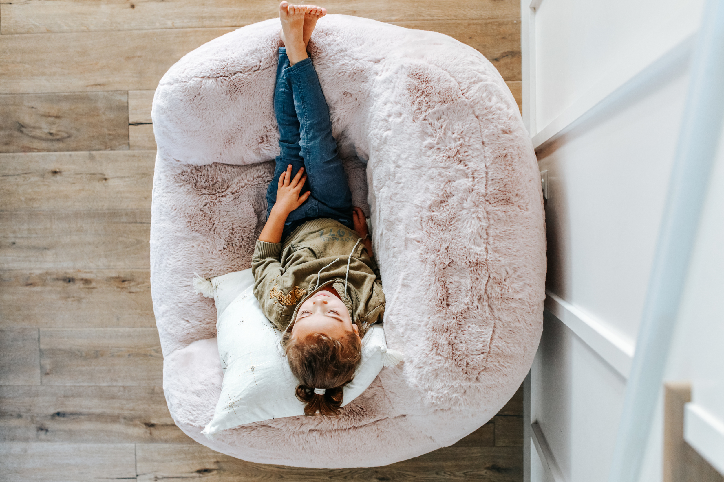 kid sitting on fuzzy chair