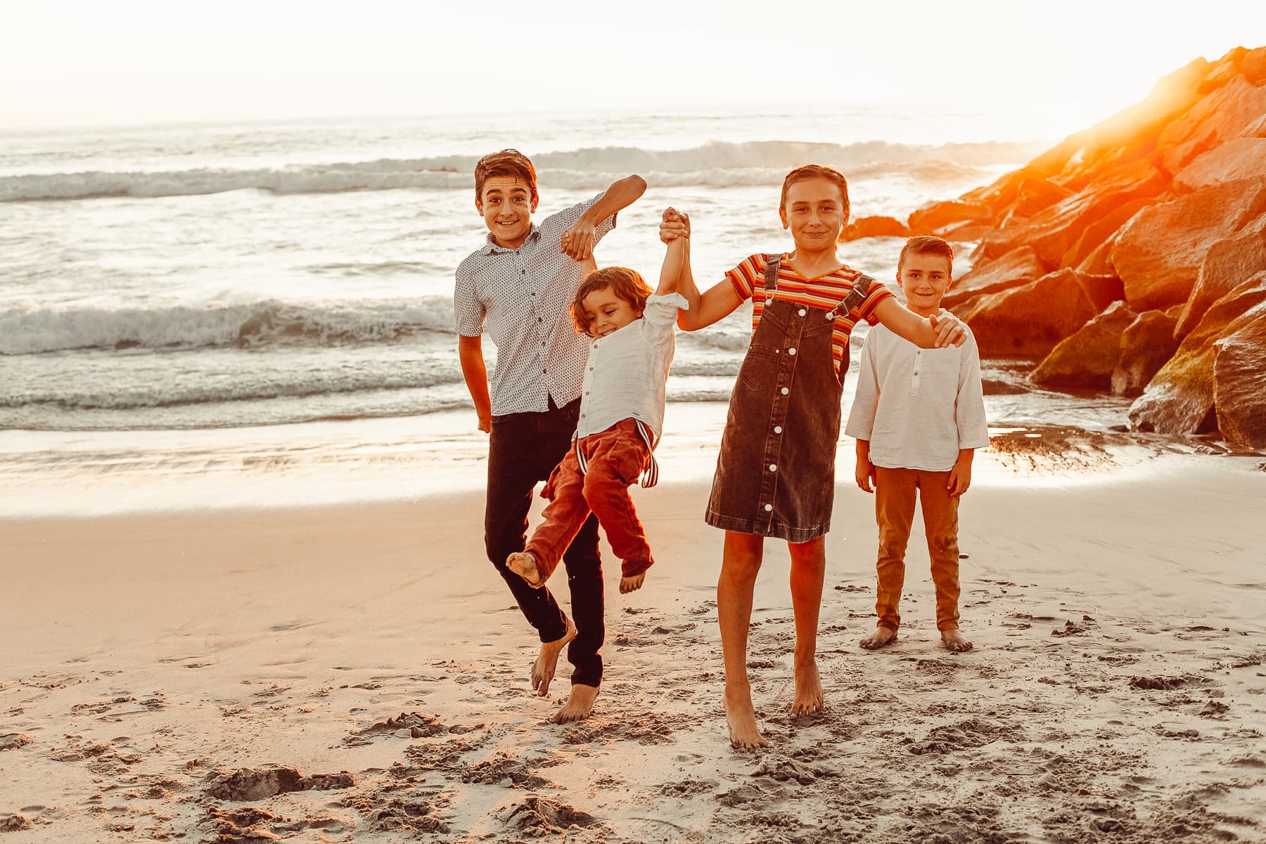 kids at the beach at sunset