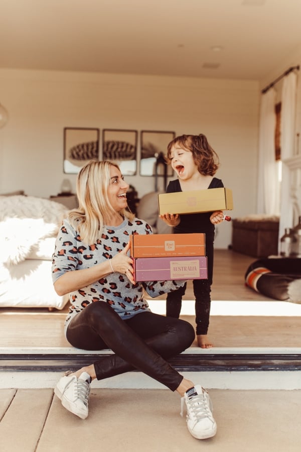 mom and son holding boxes