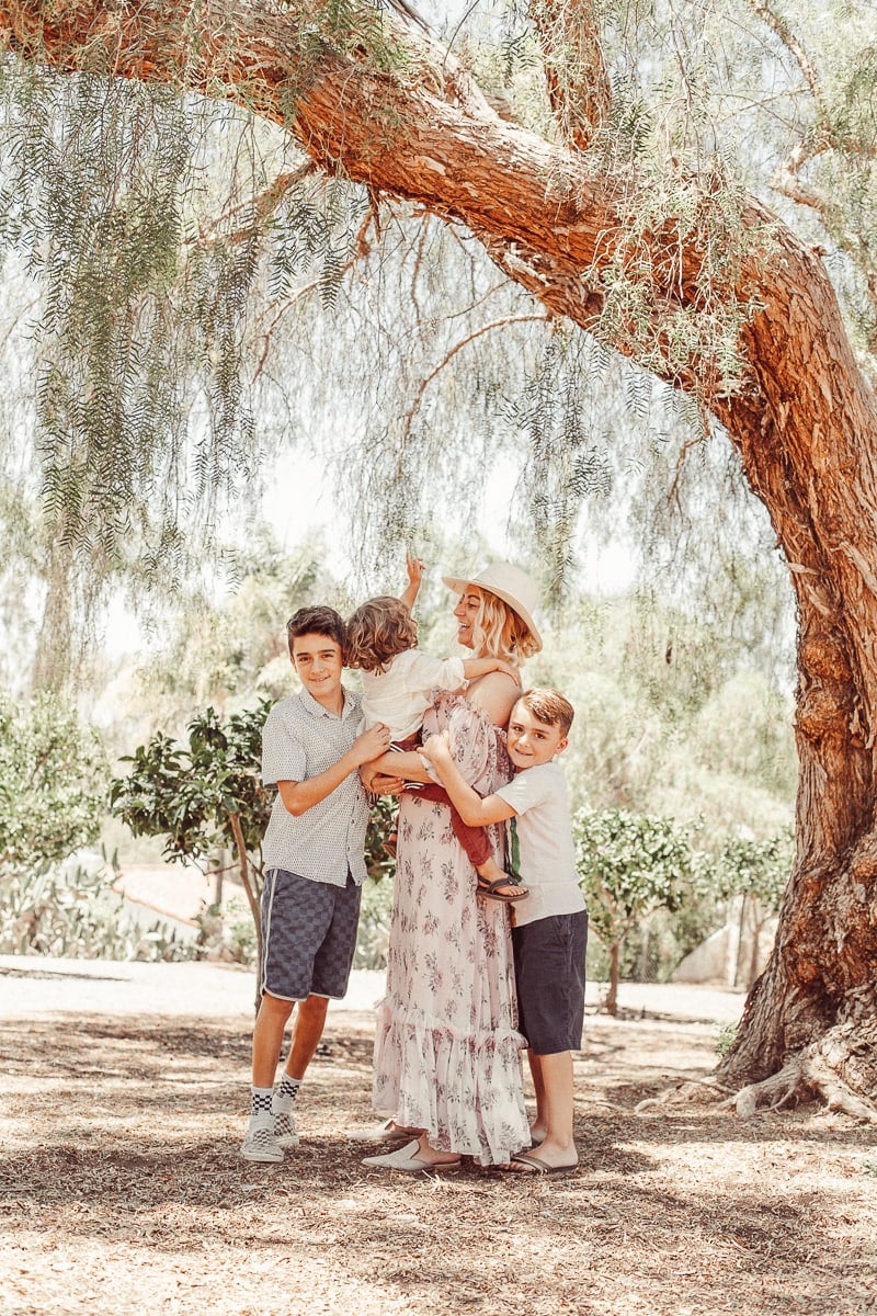 mother and children under a tree