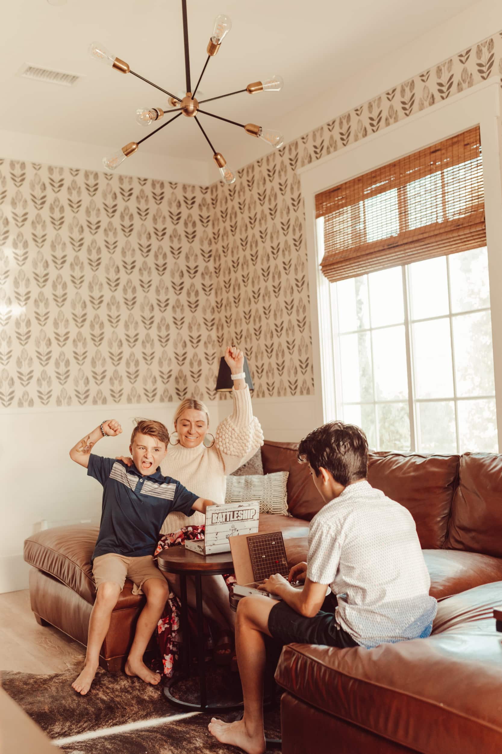 A mom playing board games with her sons and winning.