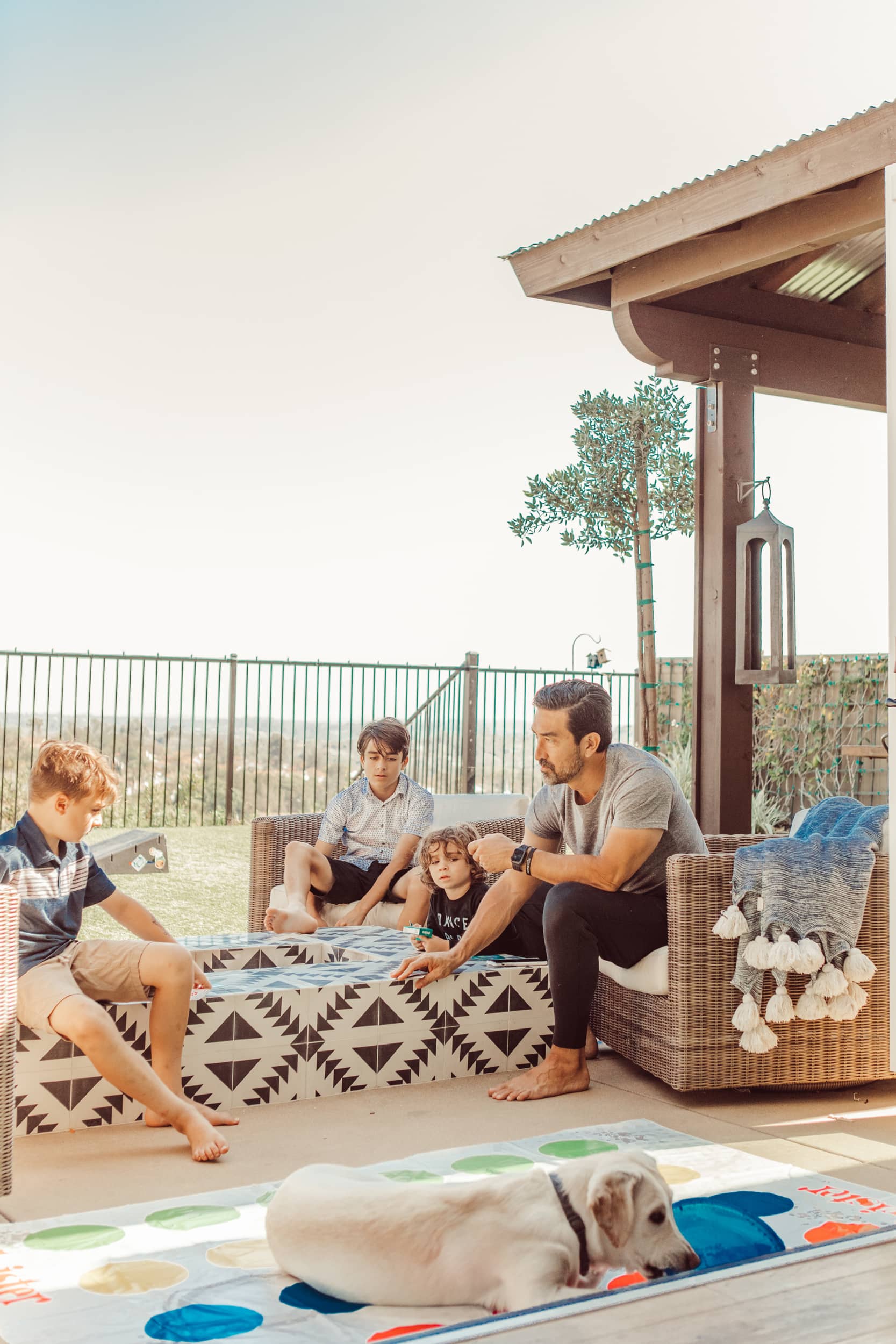 family sitting outside with dog