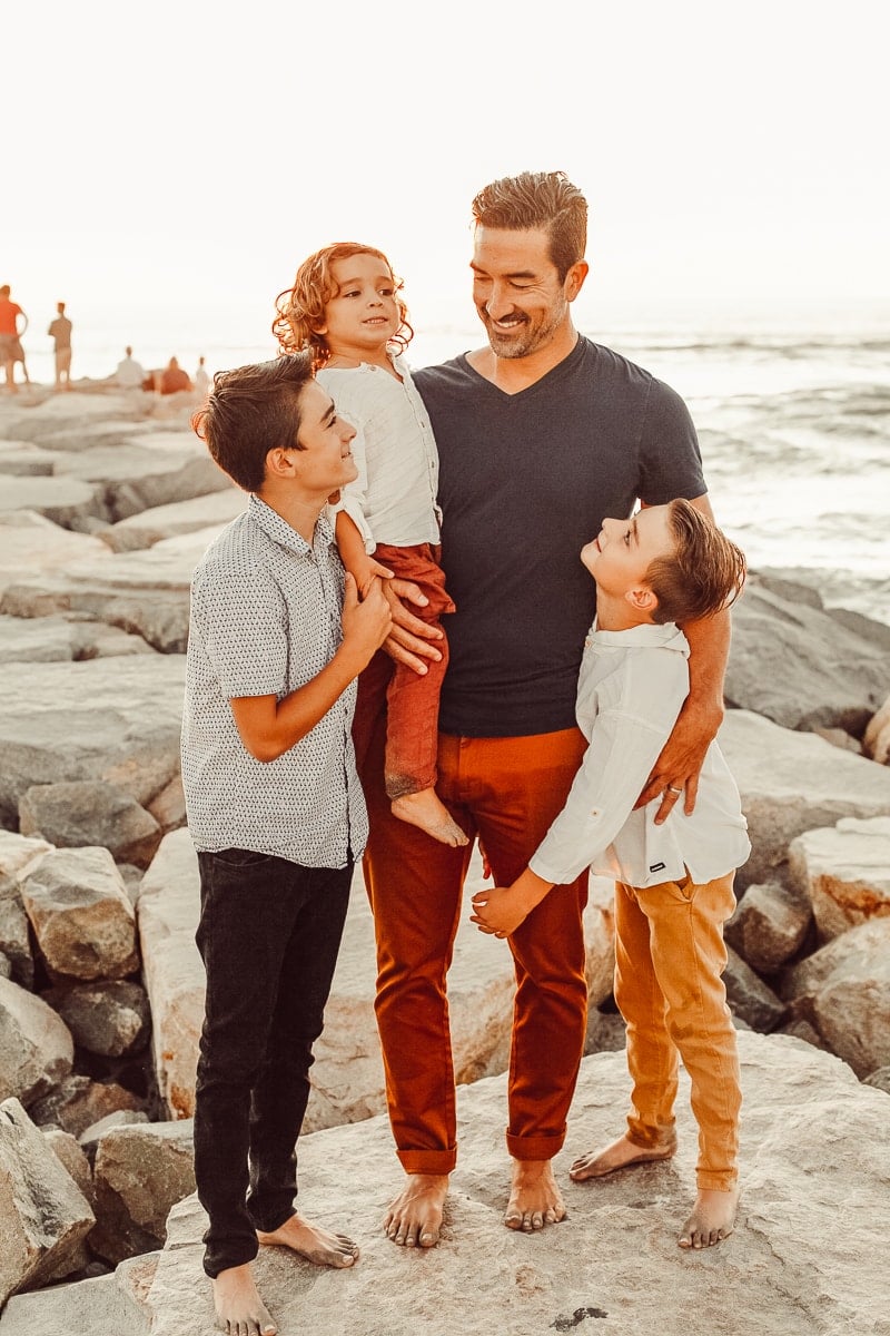 father and sons at the beach