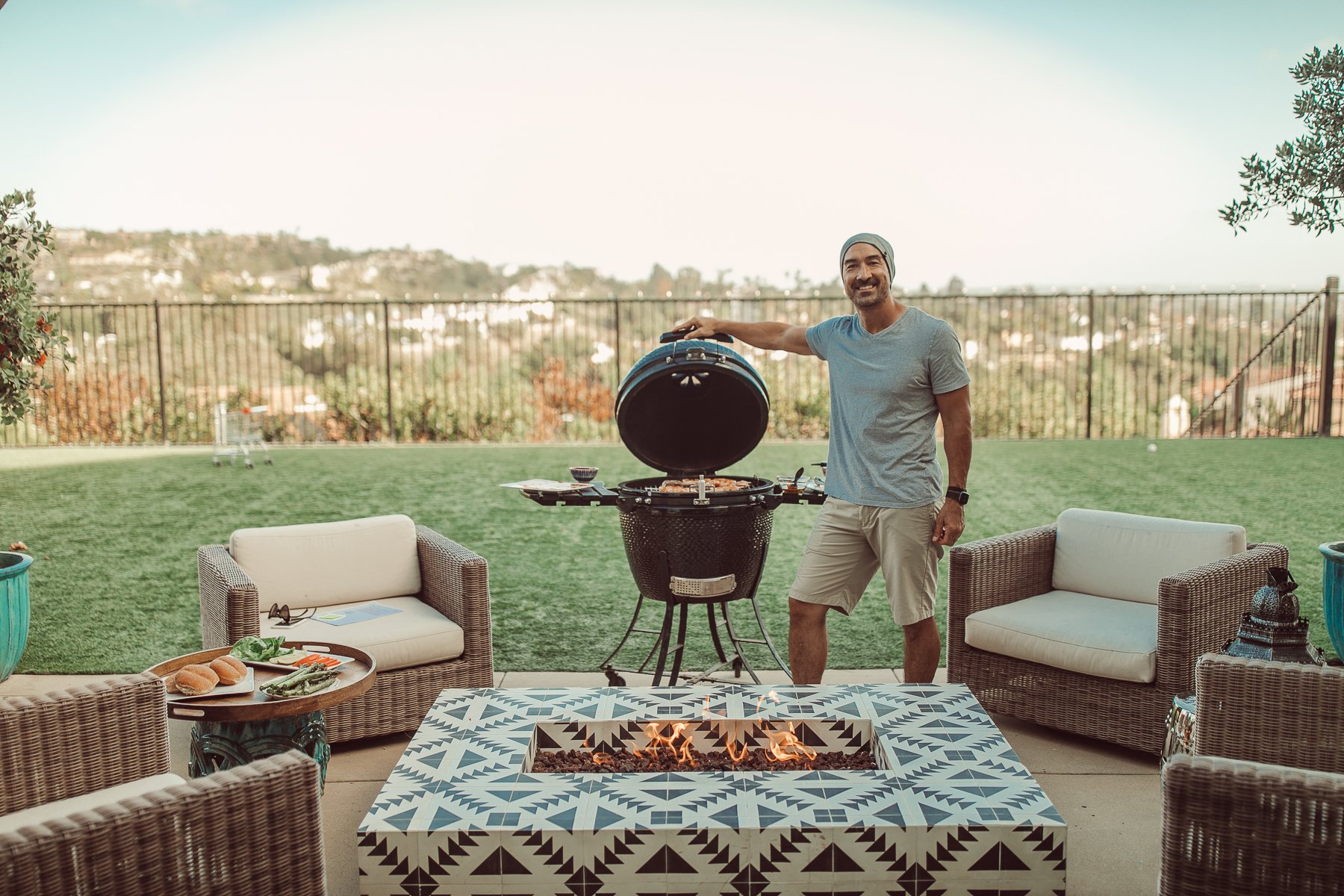 man barbecuing in backyard