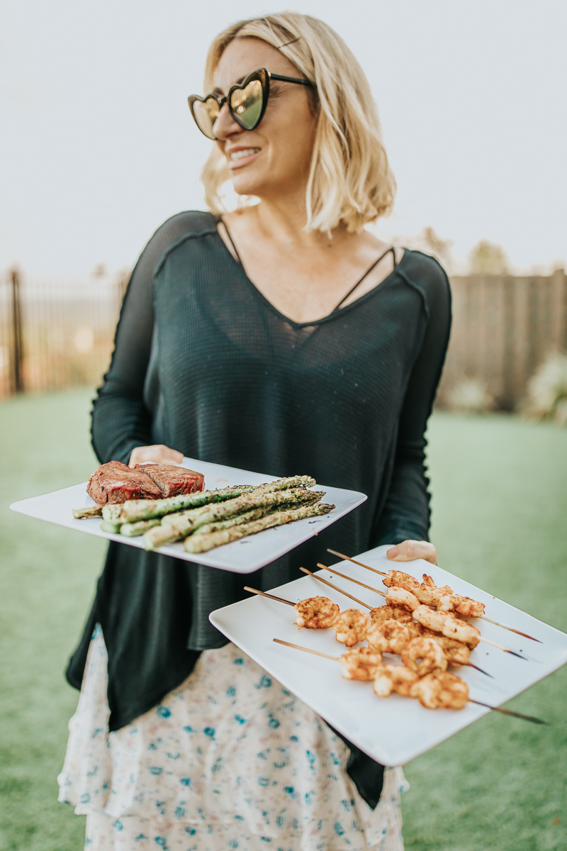 woman holding barbecue plates
