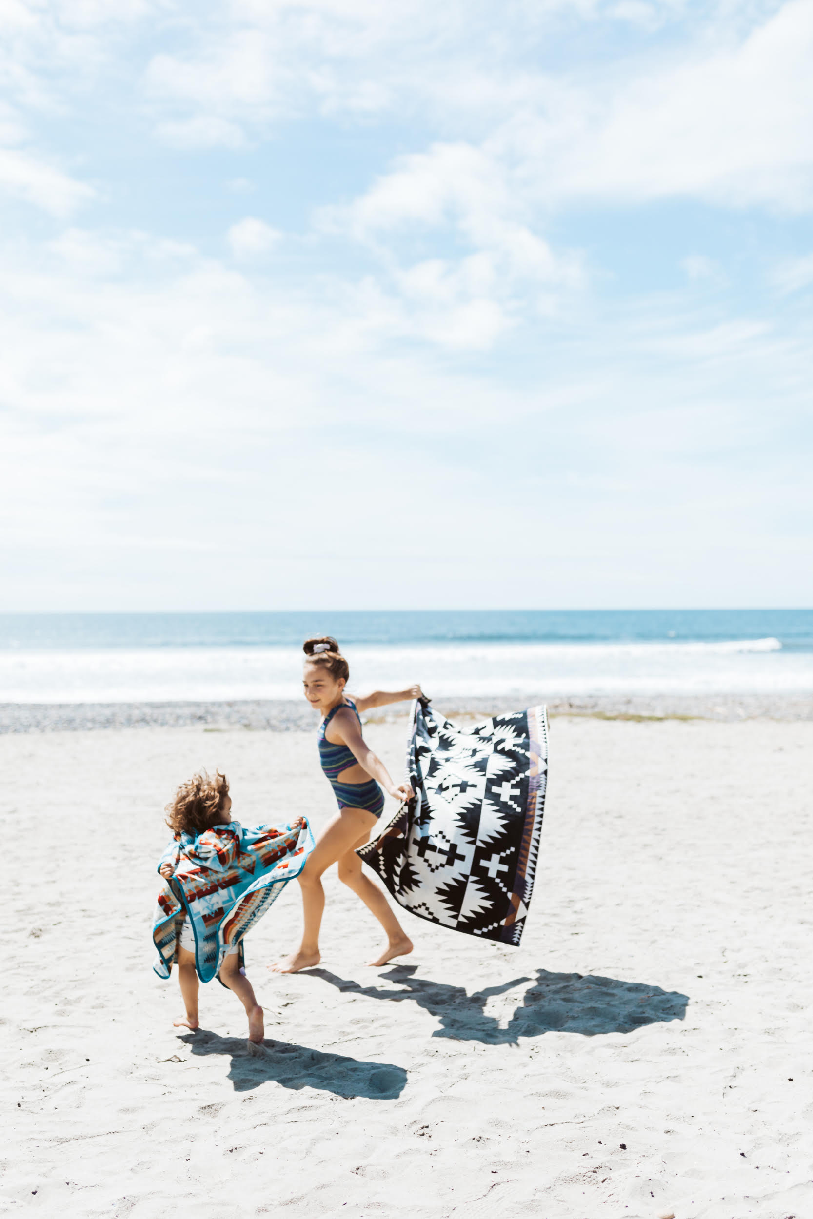 kids running on the beach