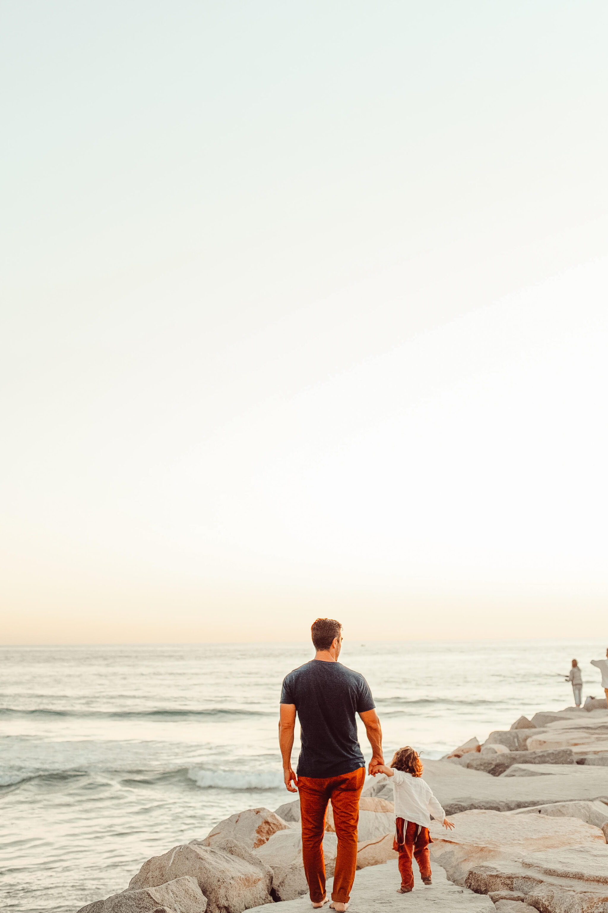 father and son walking on beach