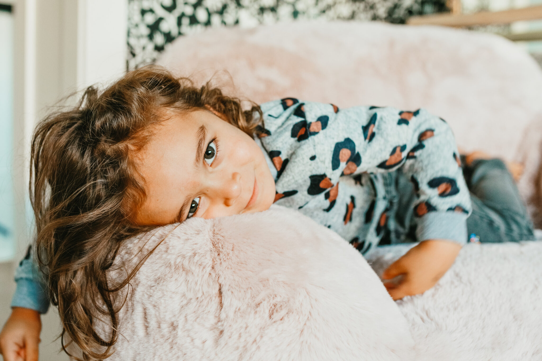 kid lying on fluffy chair