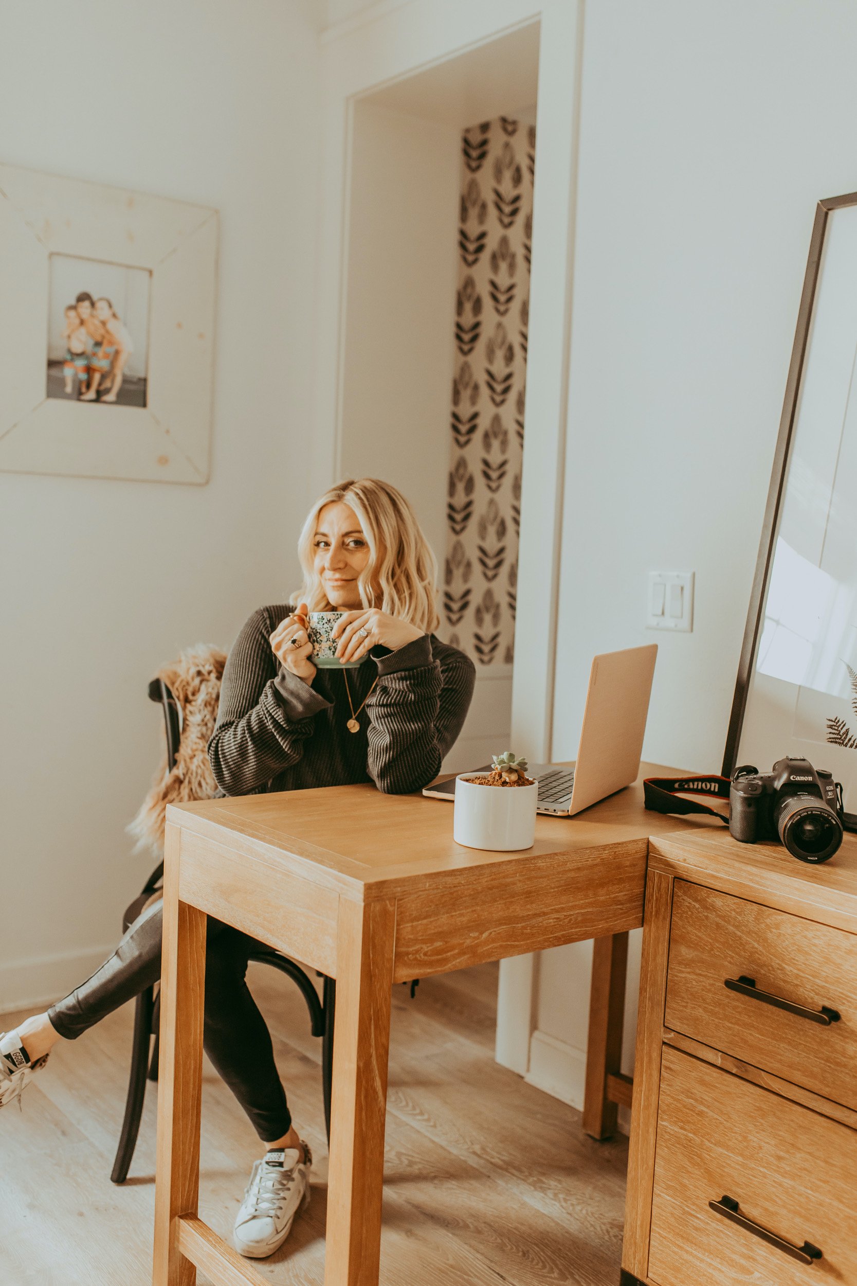 woman drinking coffee at desk