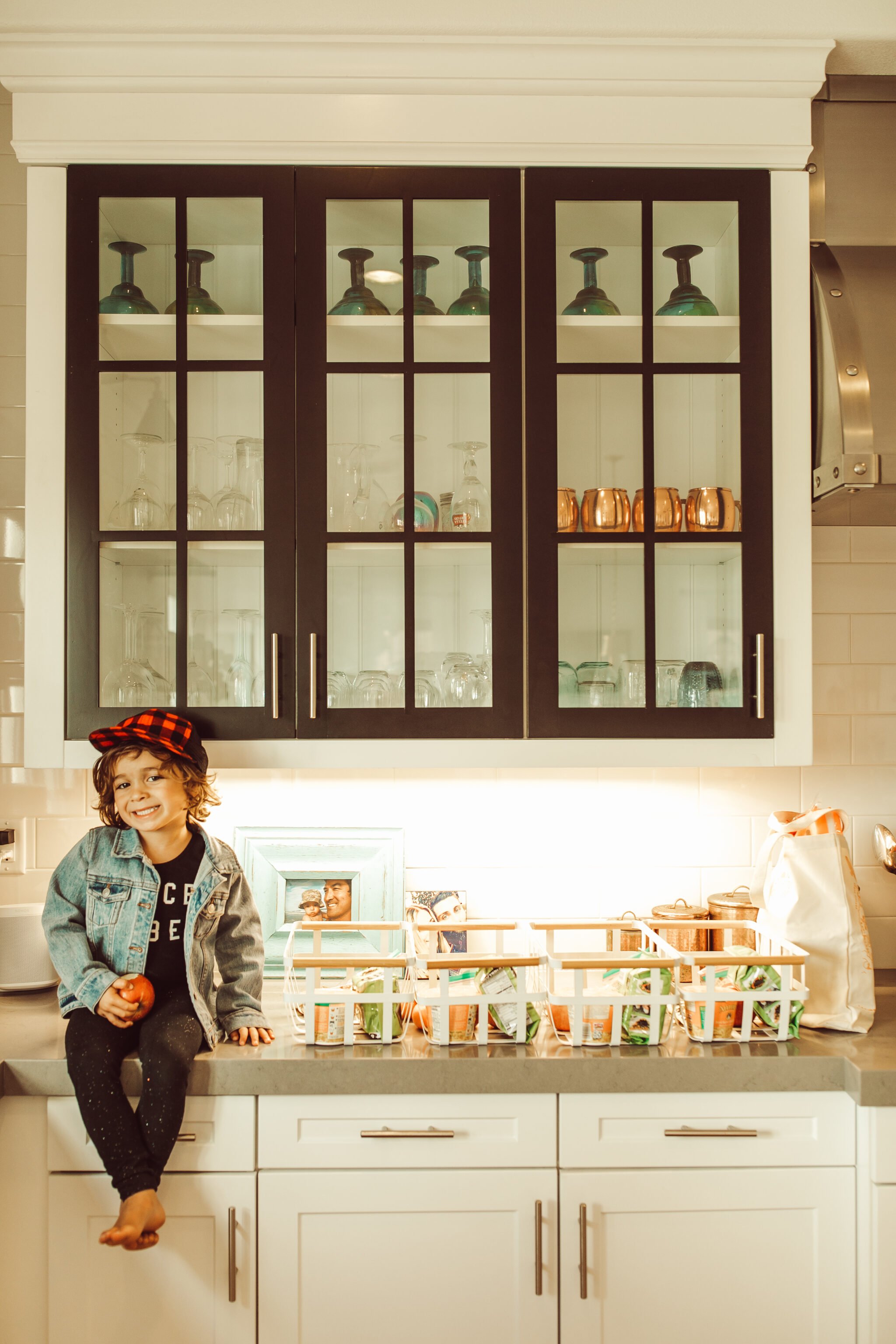 toddler sitting on kitchen counter with groceries