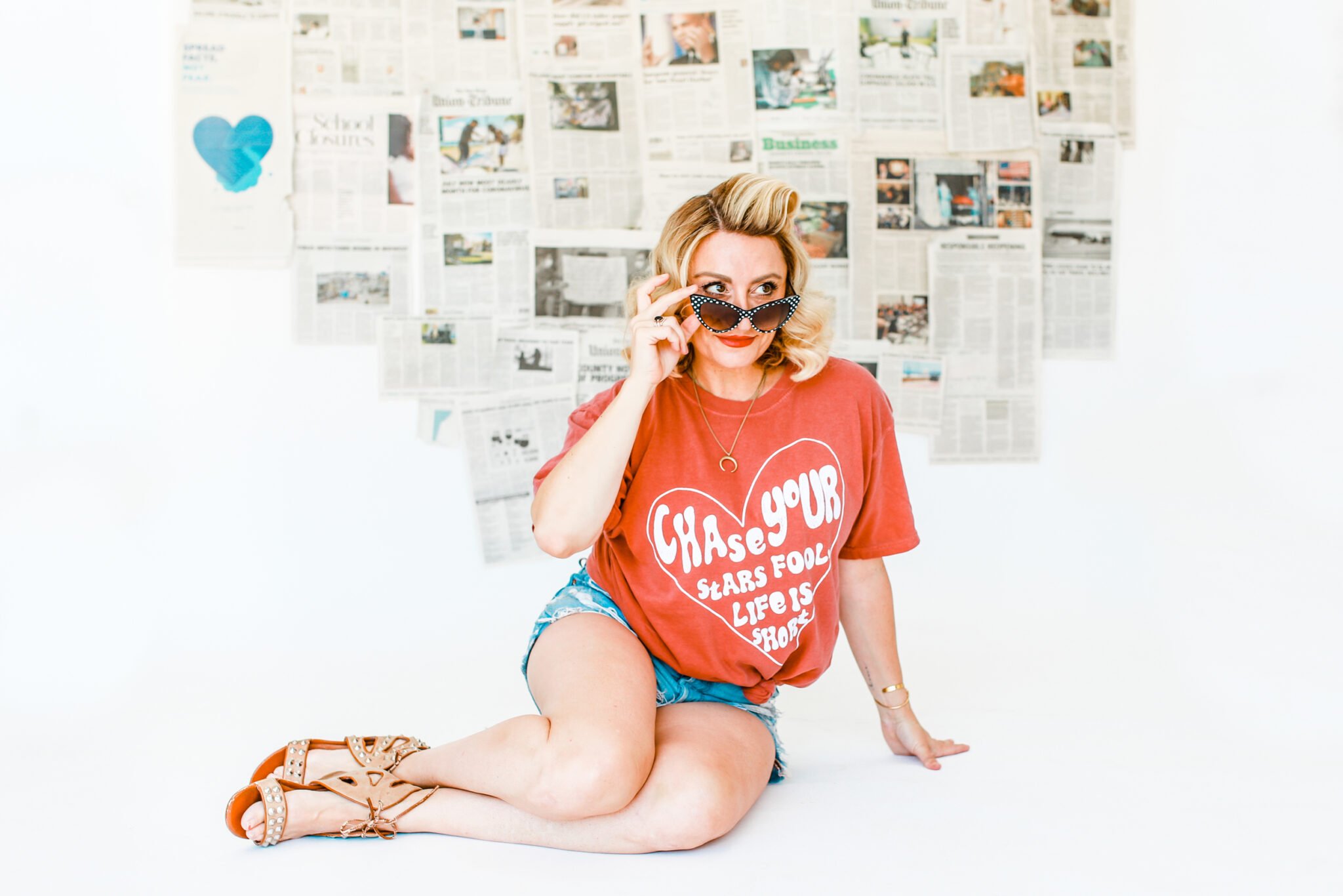 woman posing with newspaper