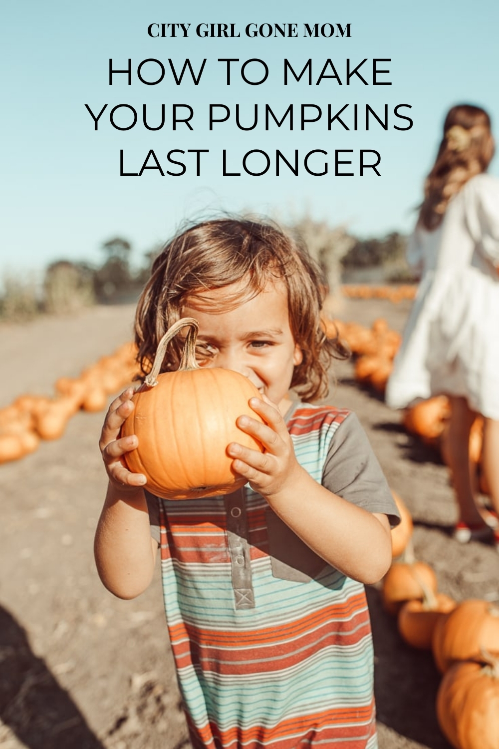 toddler with pumpkin