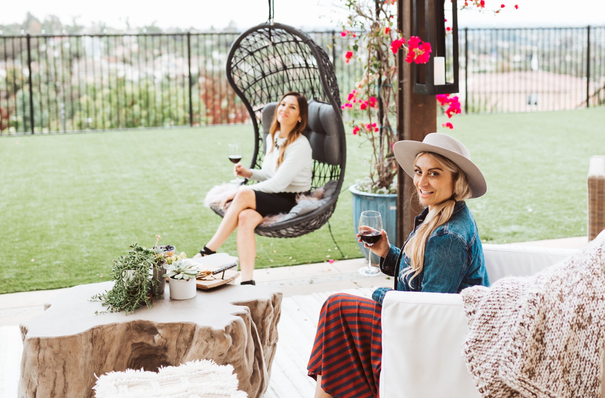 women drinking wine on patio