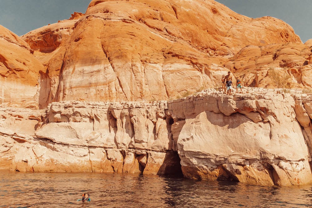 kids cliff jumping into lake