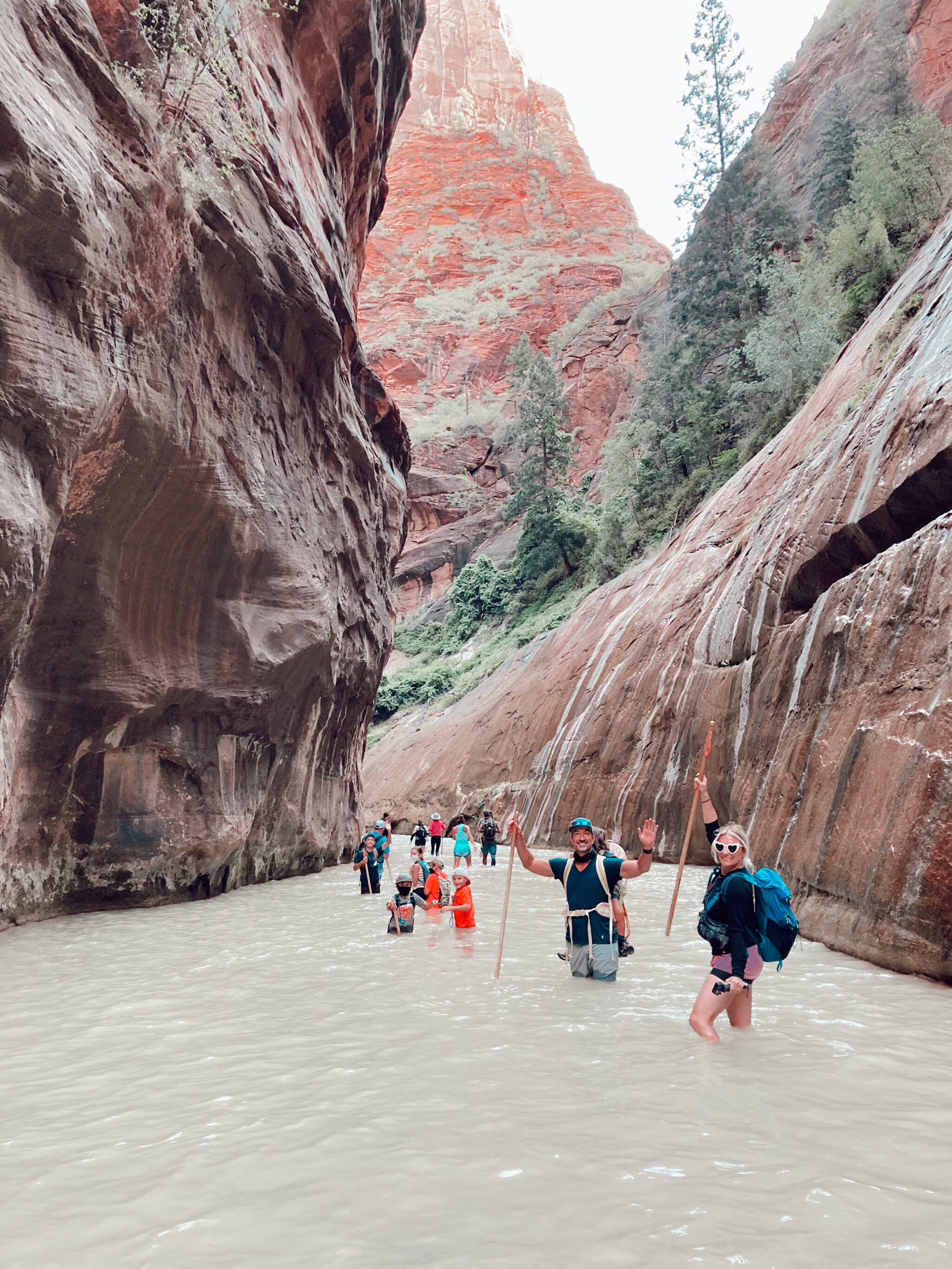 family hiking through water