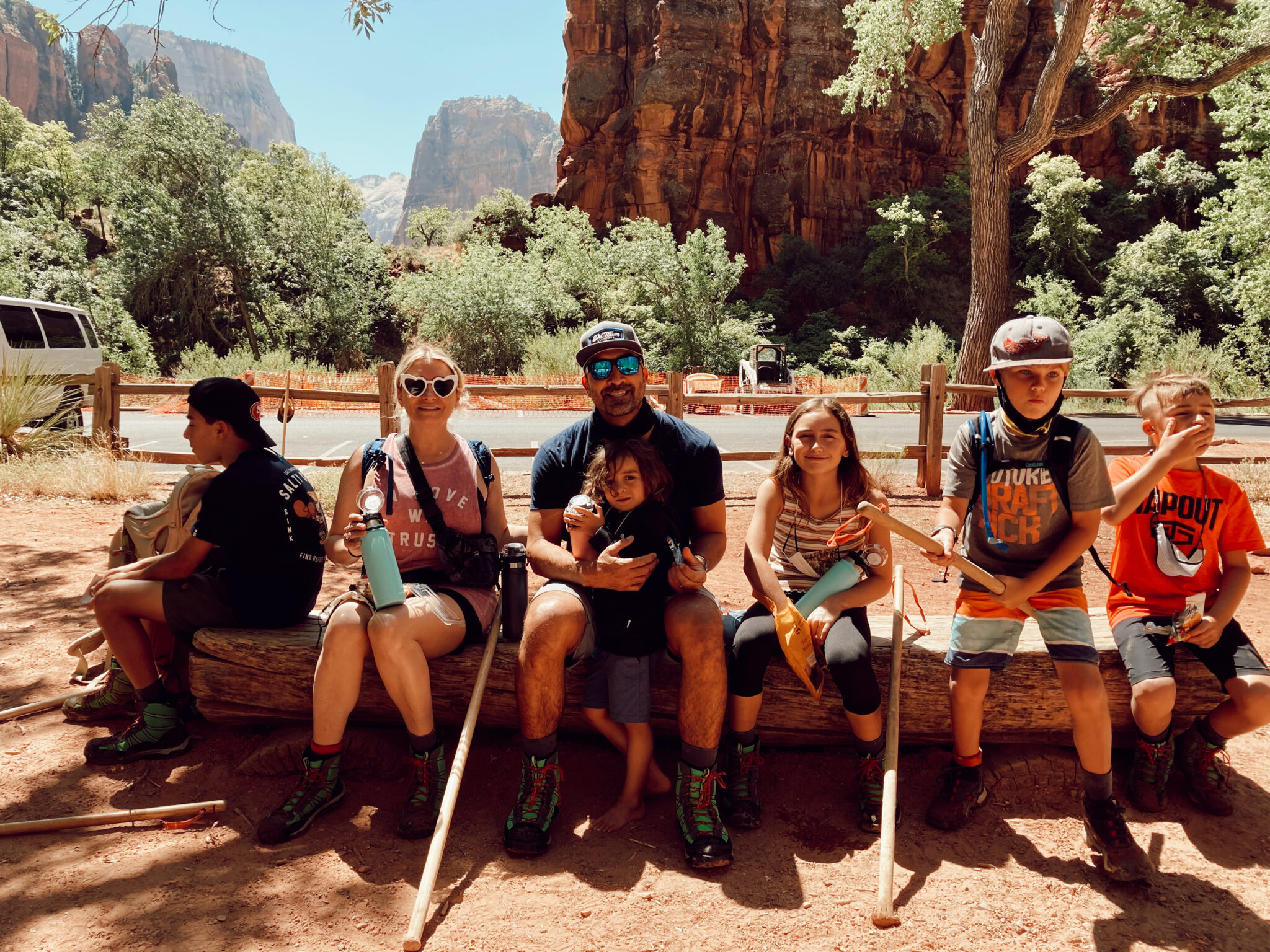 family sitting on a log