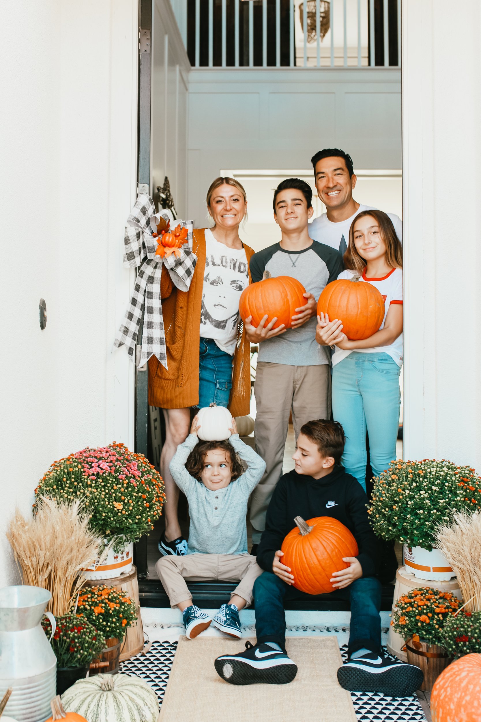 family holding pumpkins