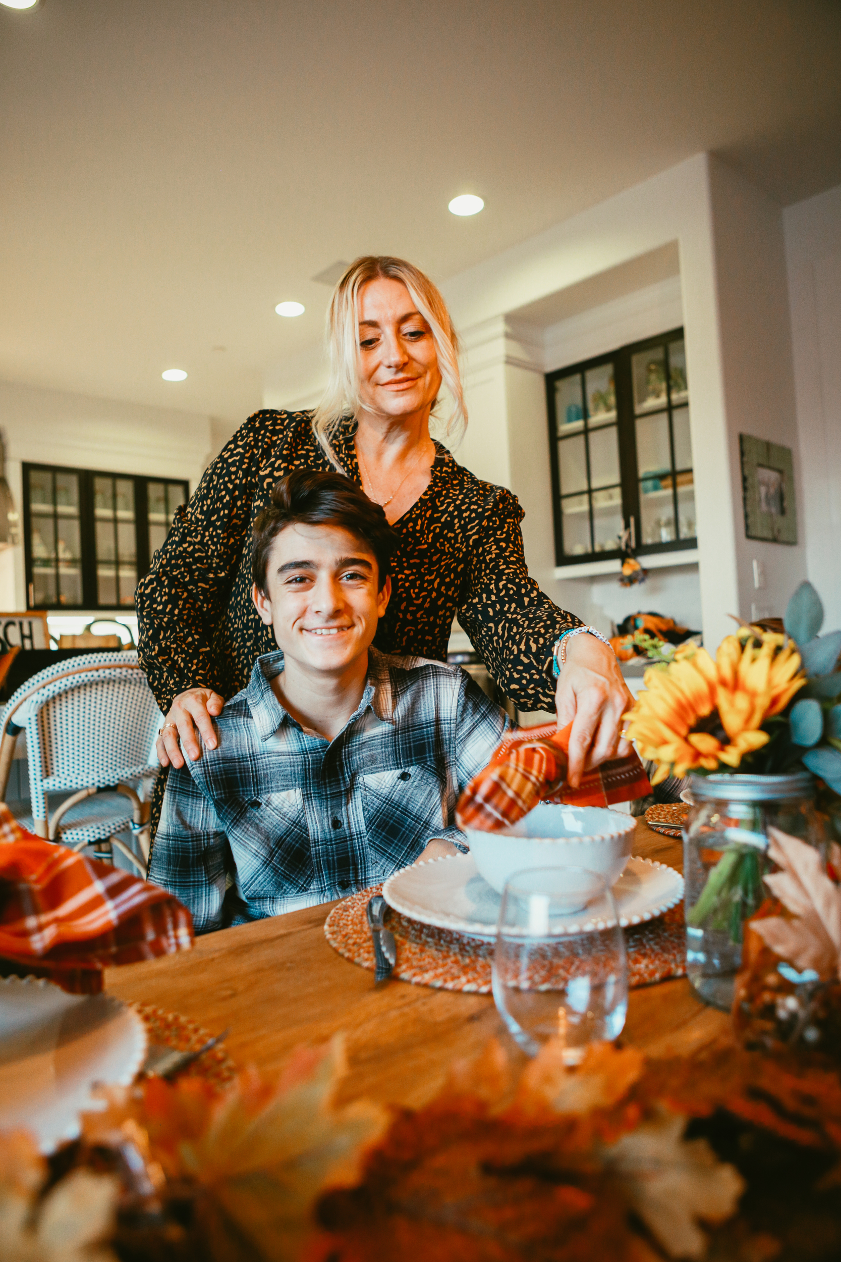 mom setting the table with son