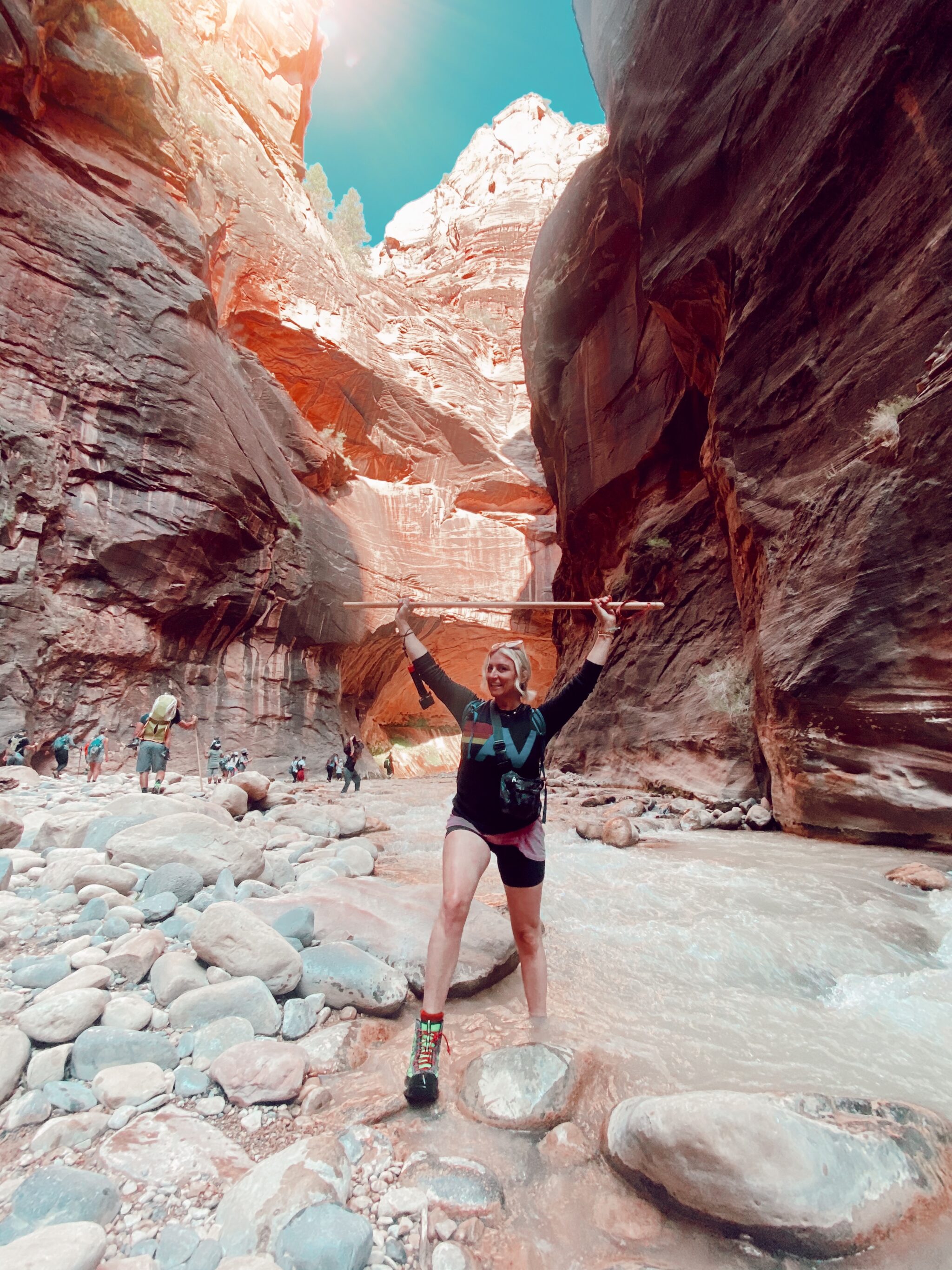 woman holding up walking stick