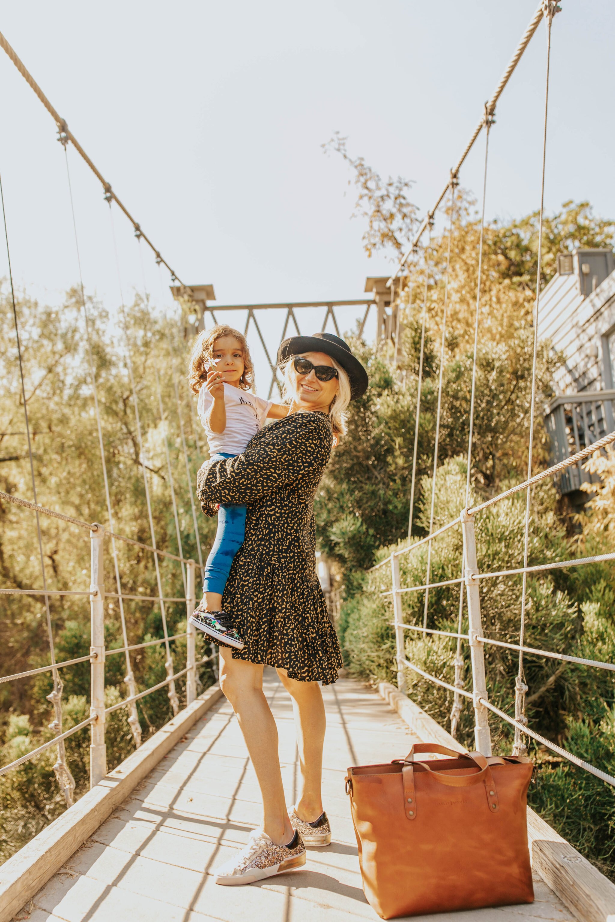 mom and toddler on bridge