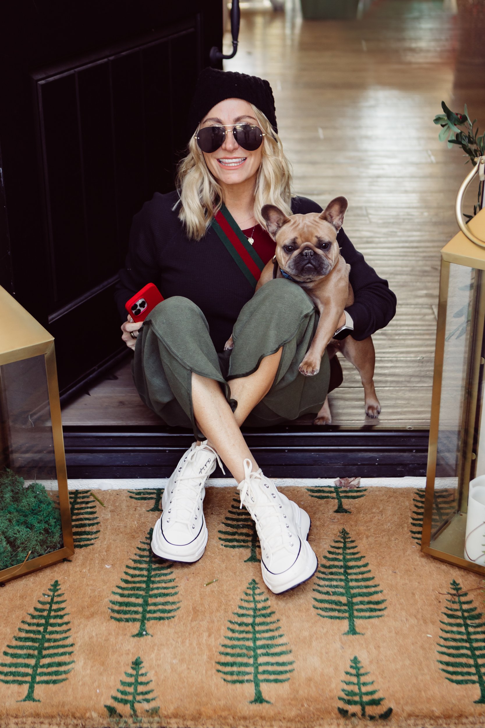 woman sitting in her doorway with her dog