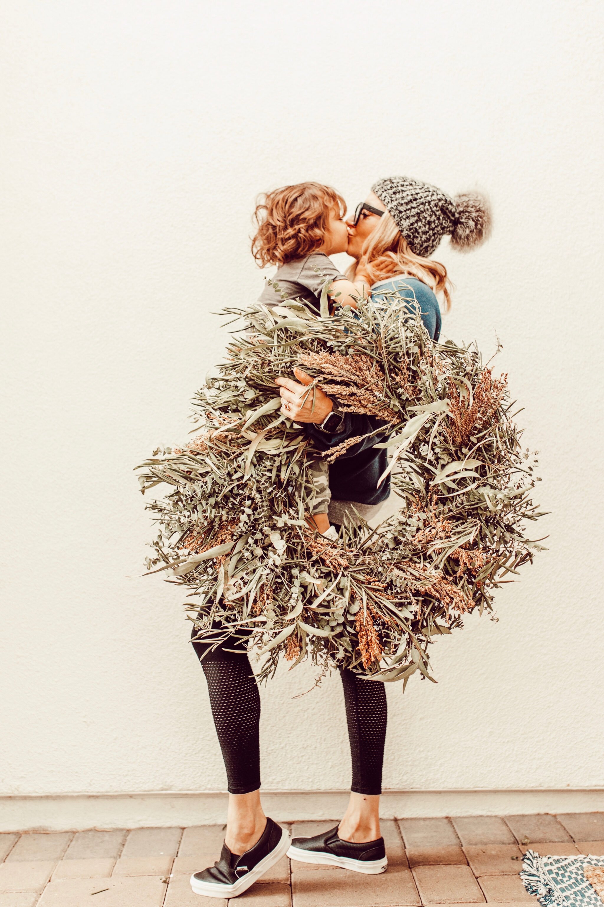 mom and son with christmas wreath