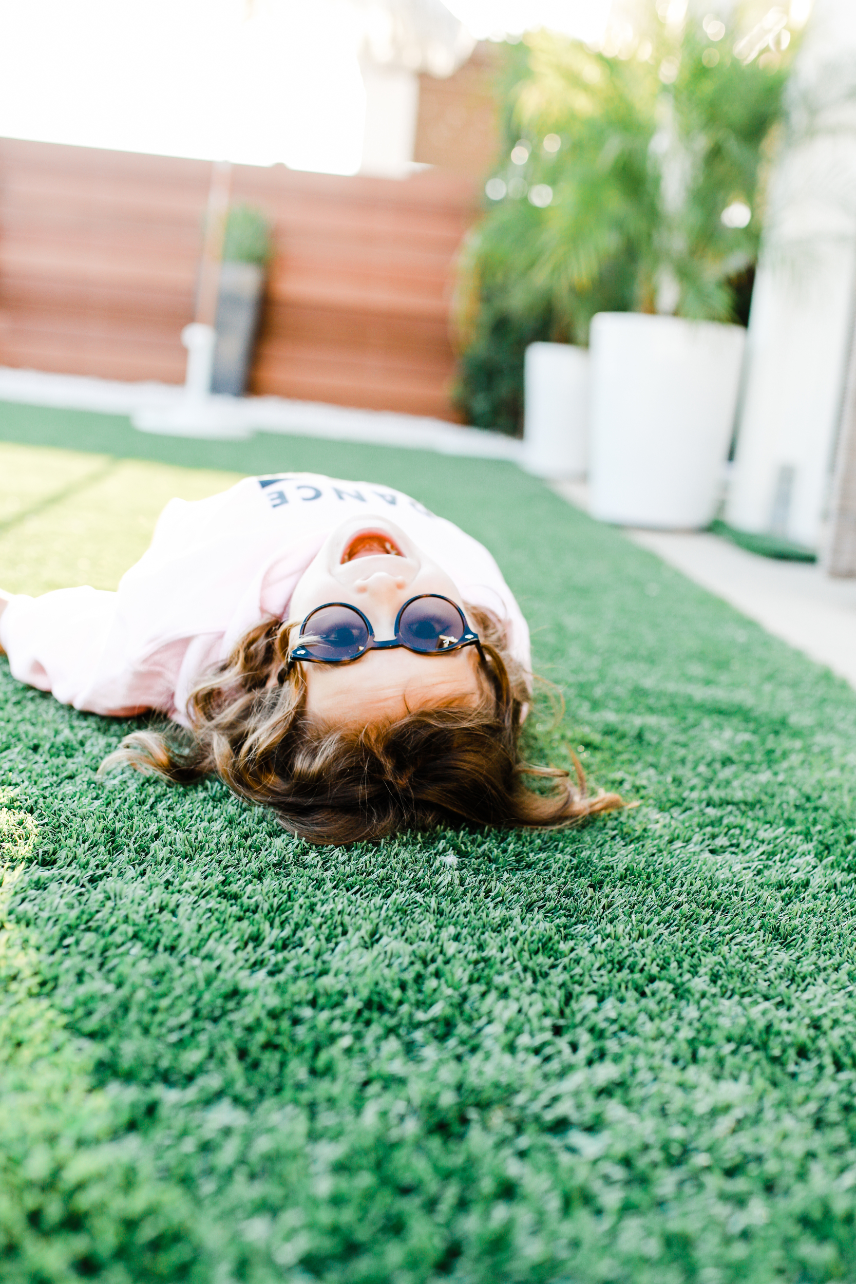 kid rolling in the grass