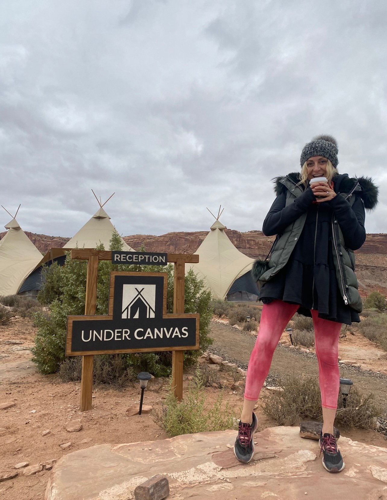 woman standing by sign