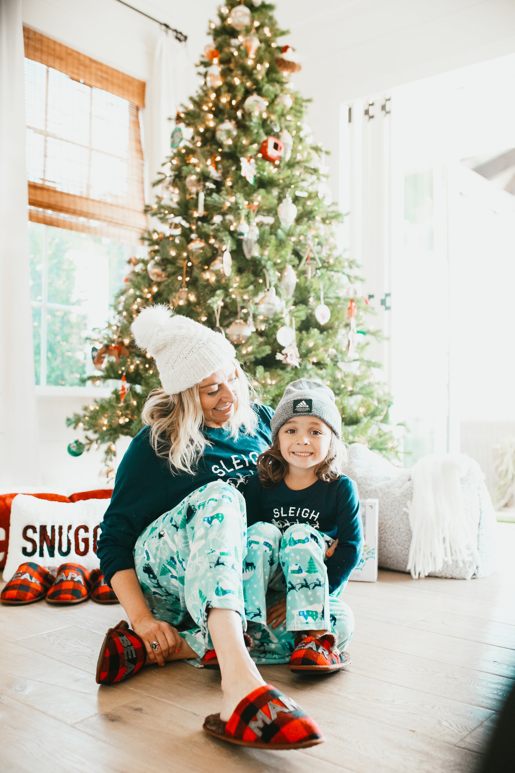 mom and son sitting by christmas tree