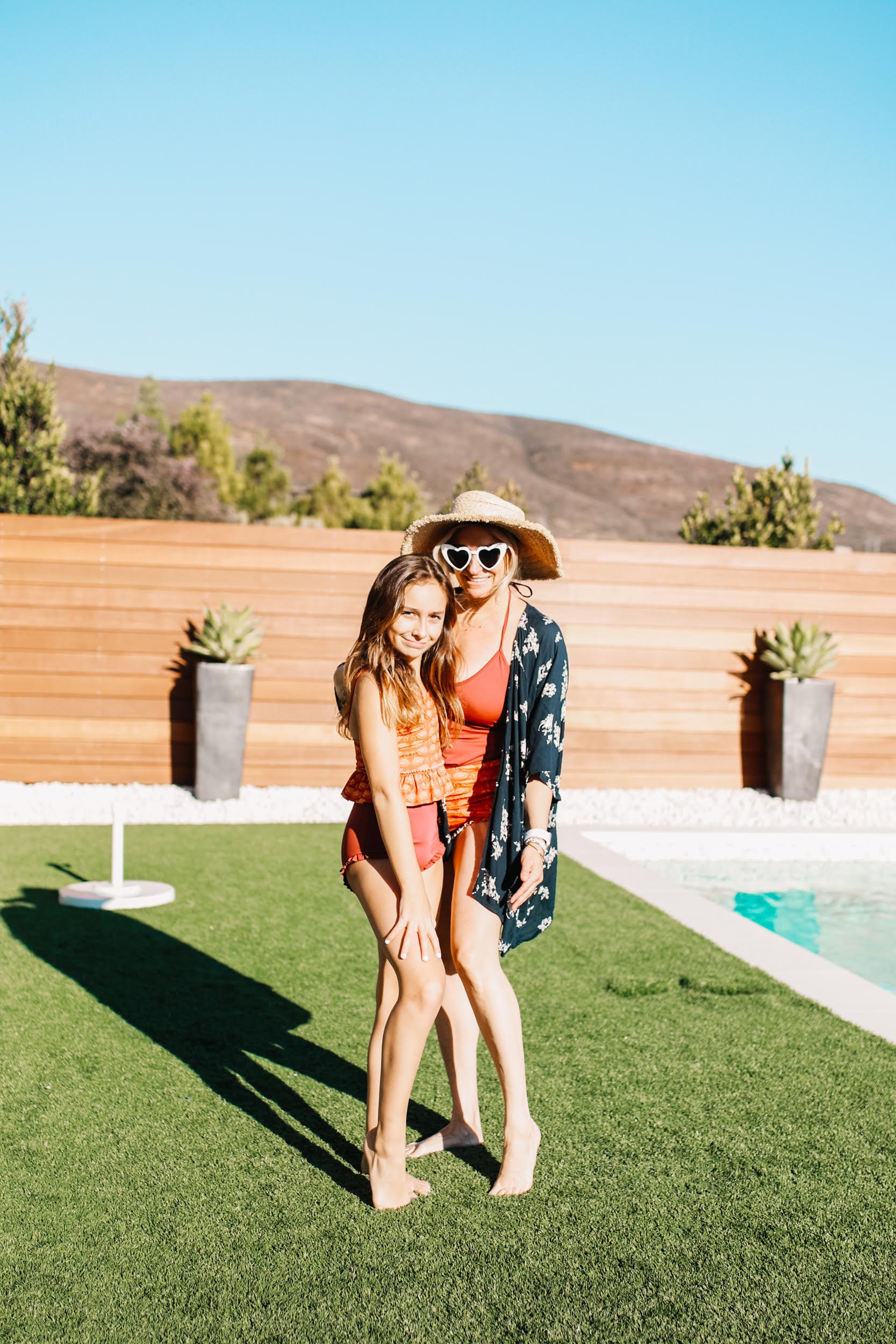 mom and daughter by the pool