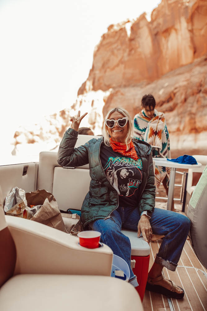 mom giving peace sign on boat