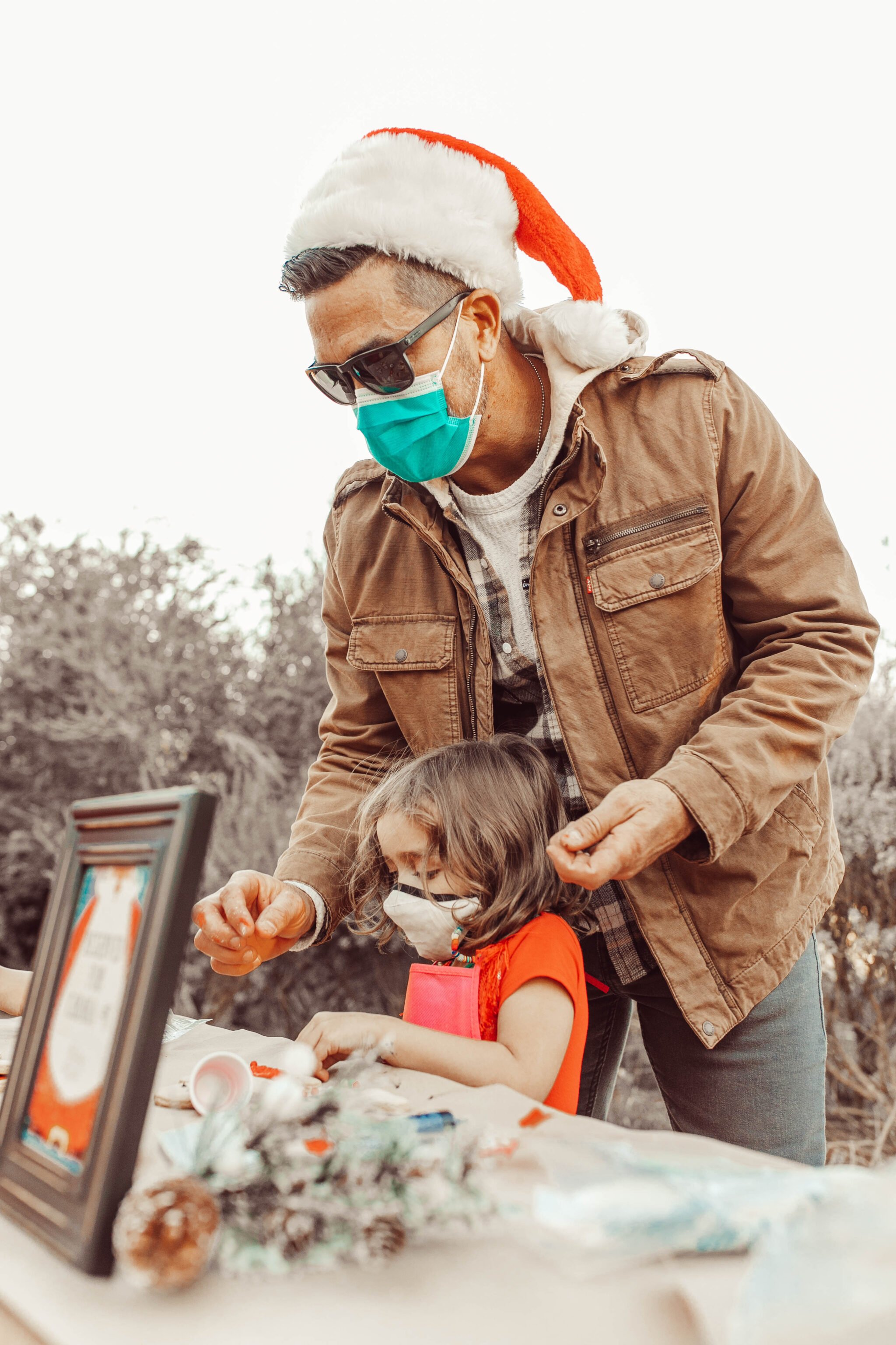 dad and kid decorating cookies