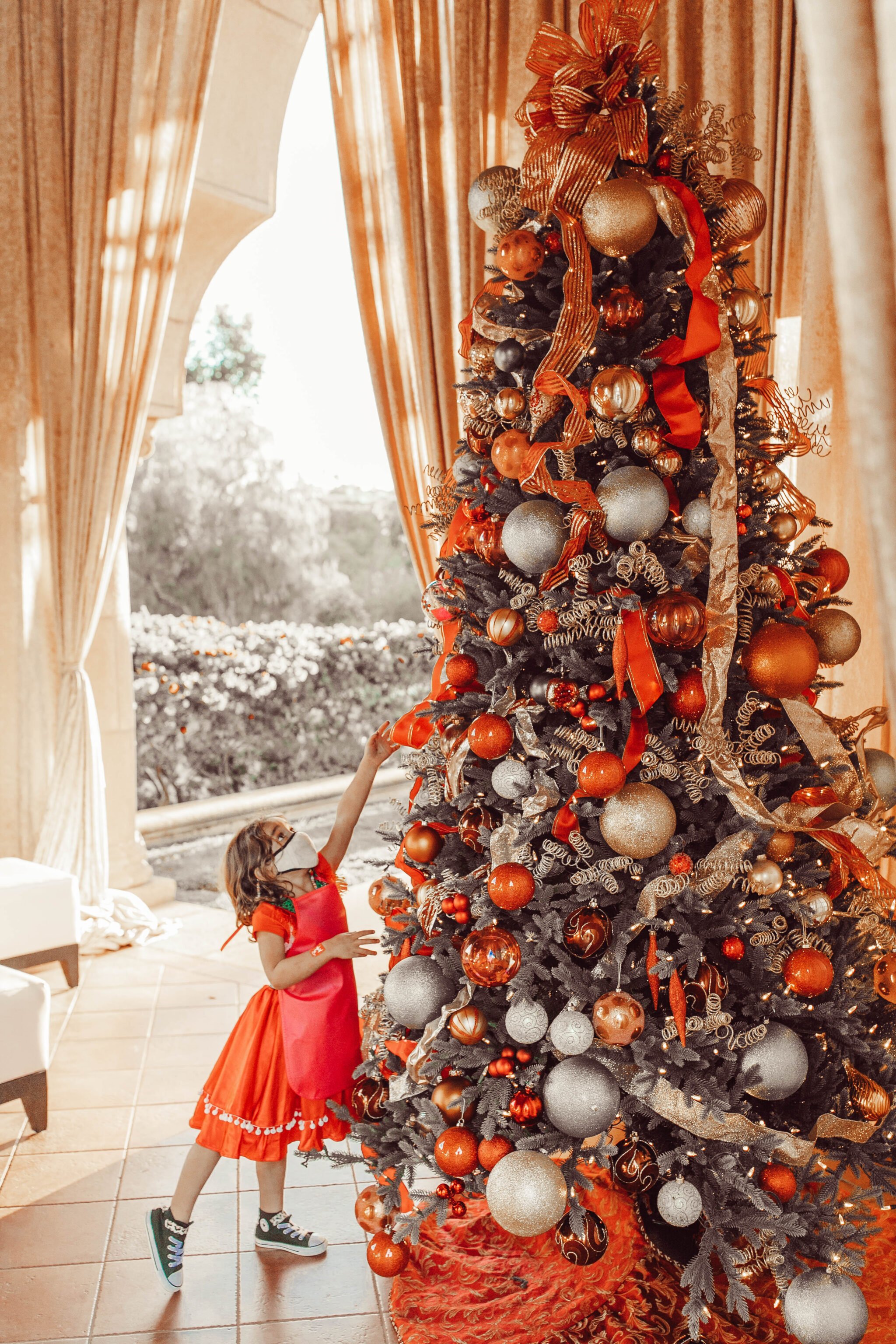 child touching christmas tree