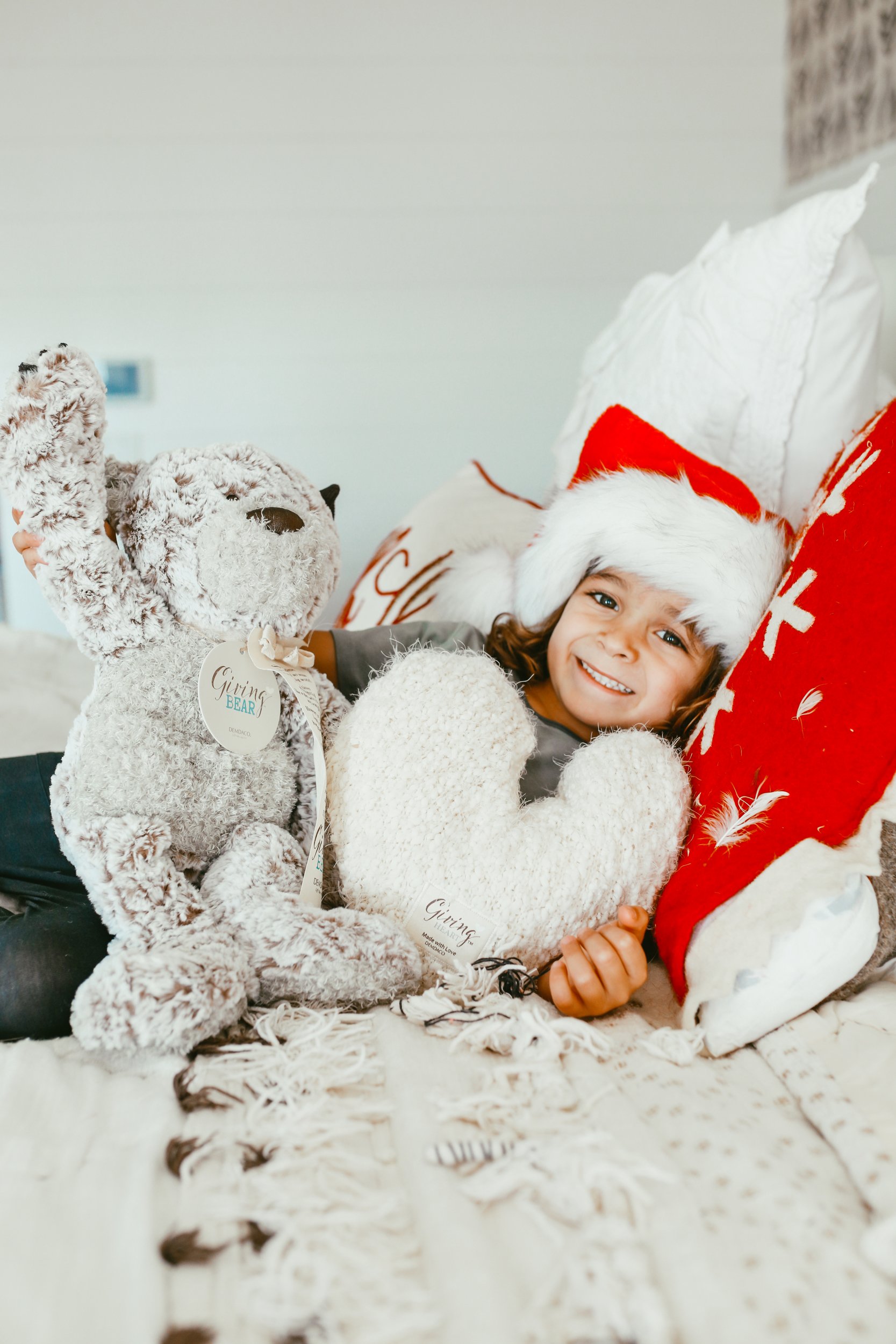 boy on bed with teddy bear