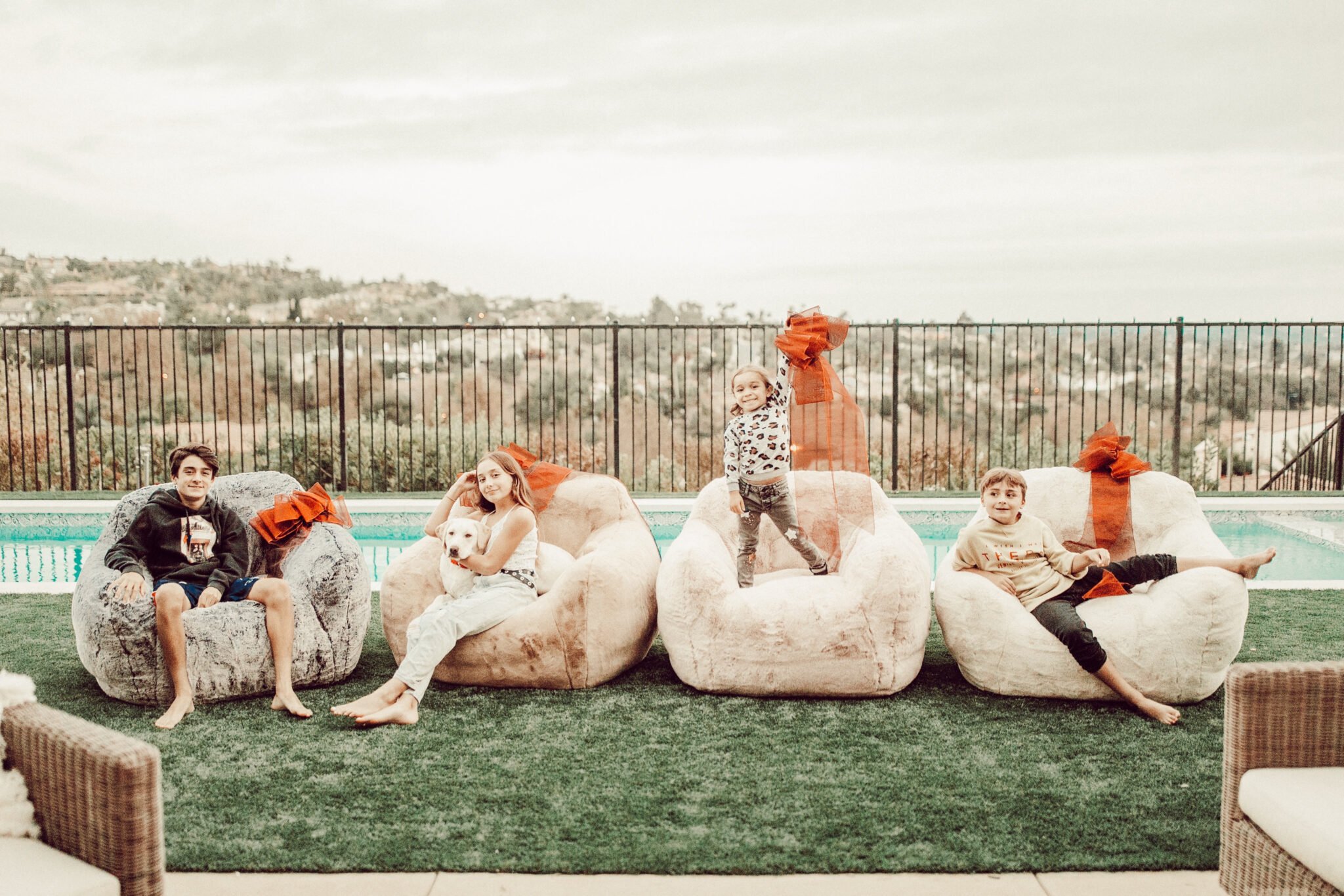 kids sitting in chairs by the pool