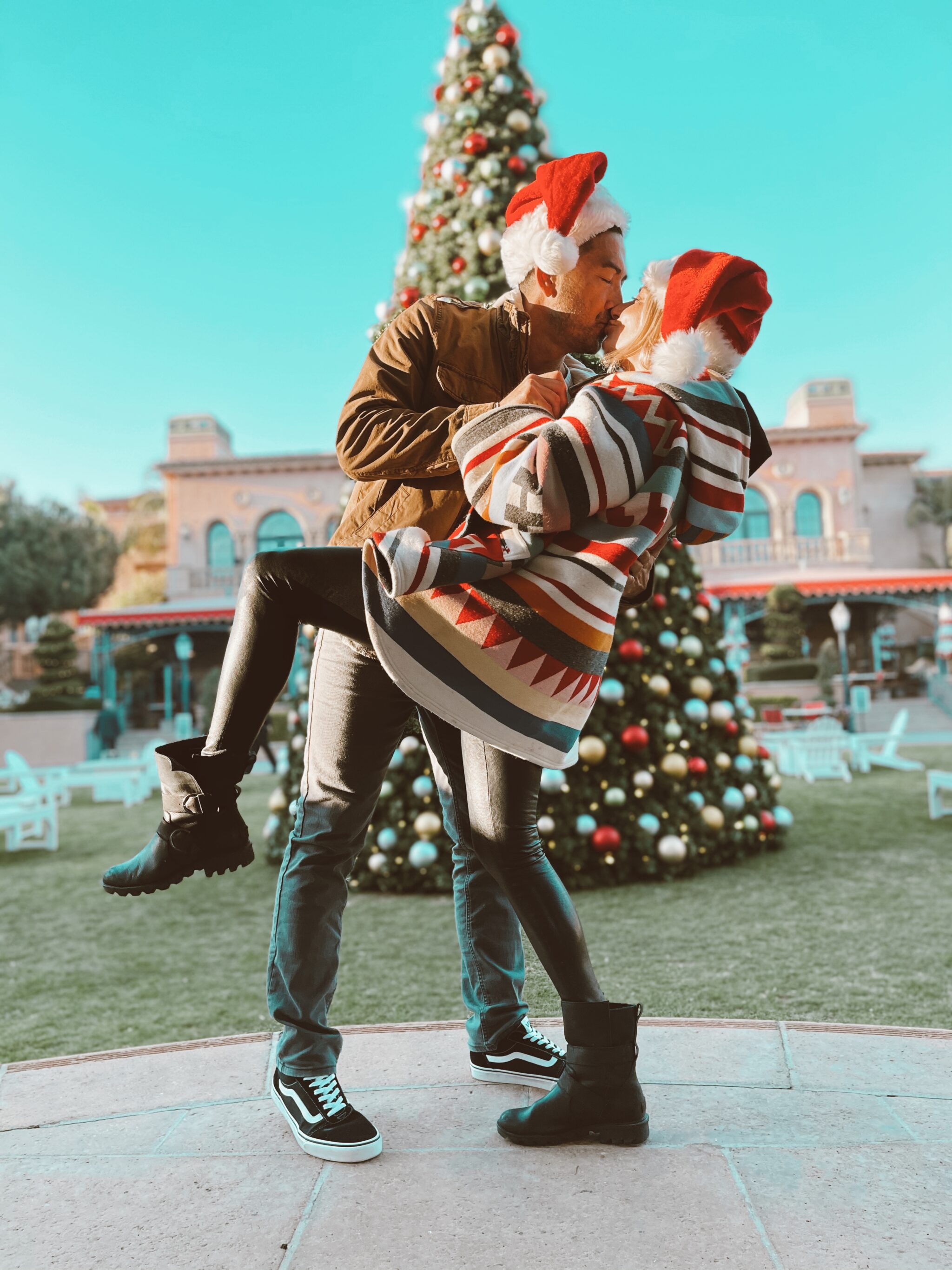 couple kissing by christmas tree