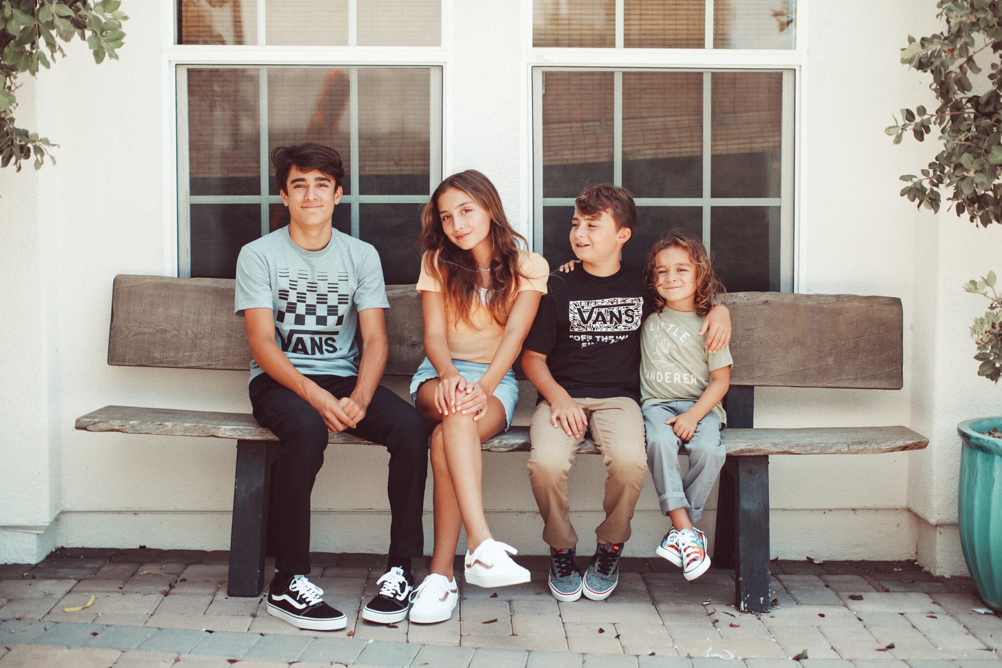 kids sitting on a bench together