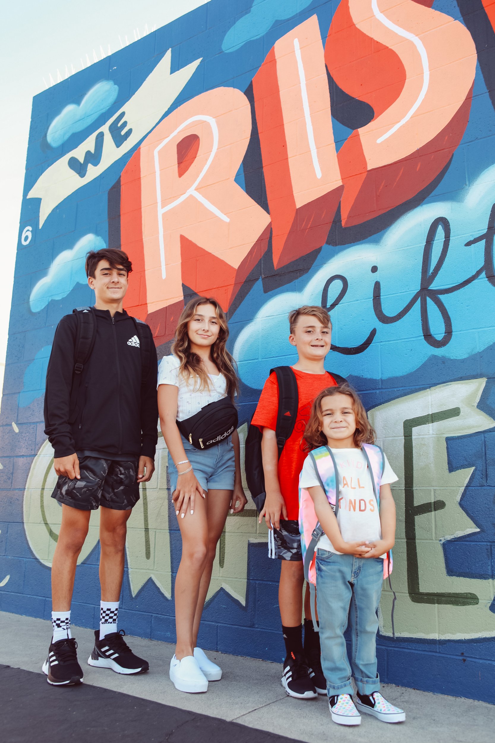 kids standing by a mural