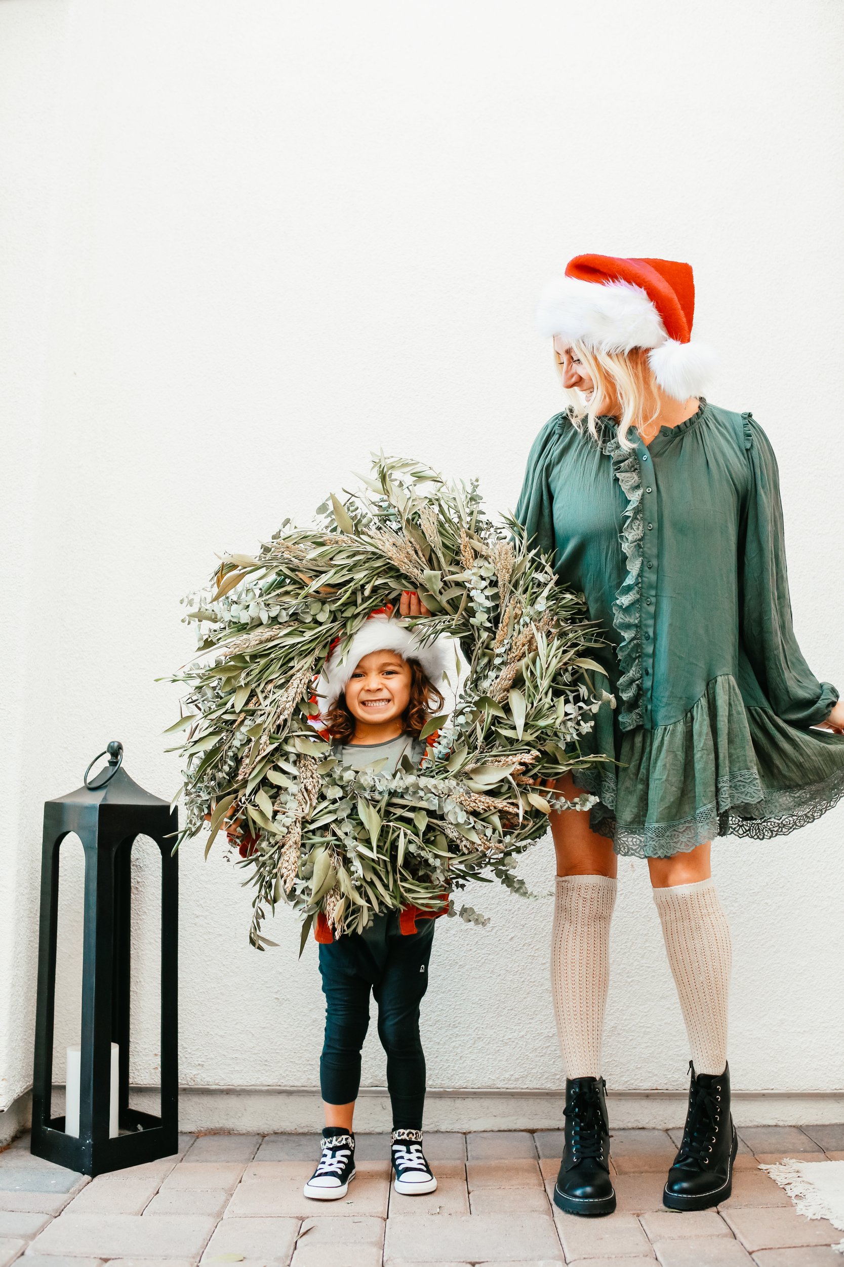 mom and son with christmas wreath