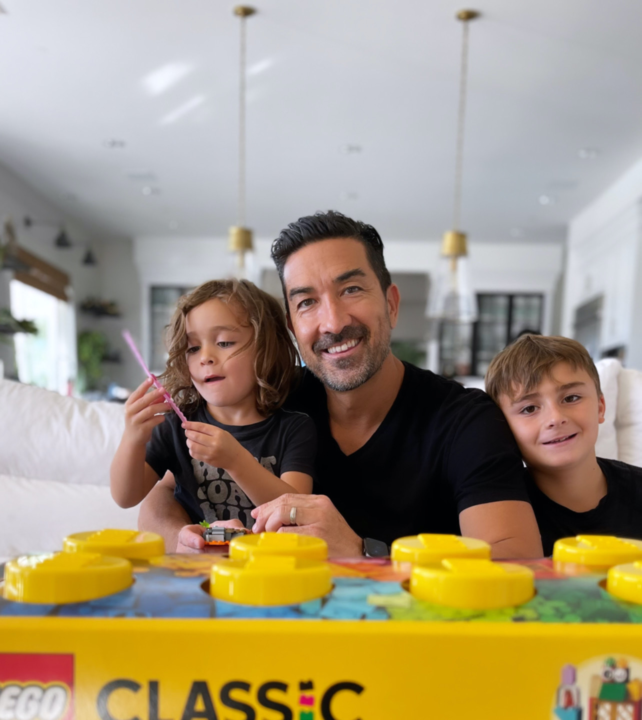 dad building legos with sons