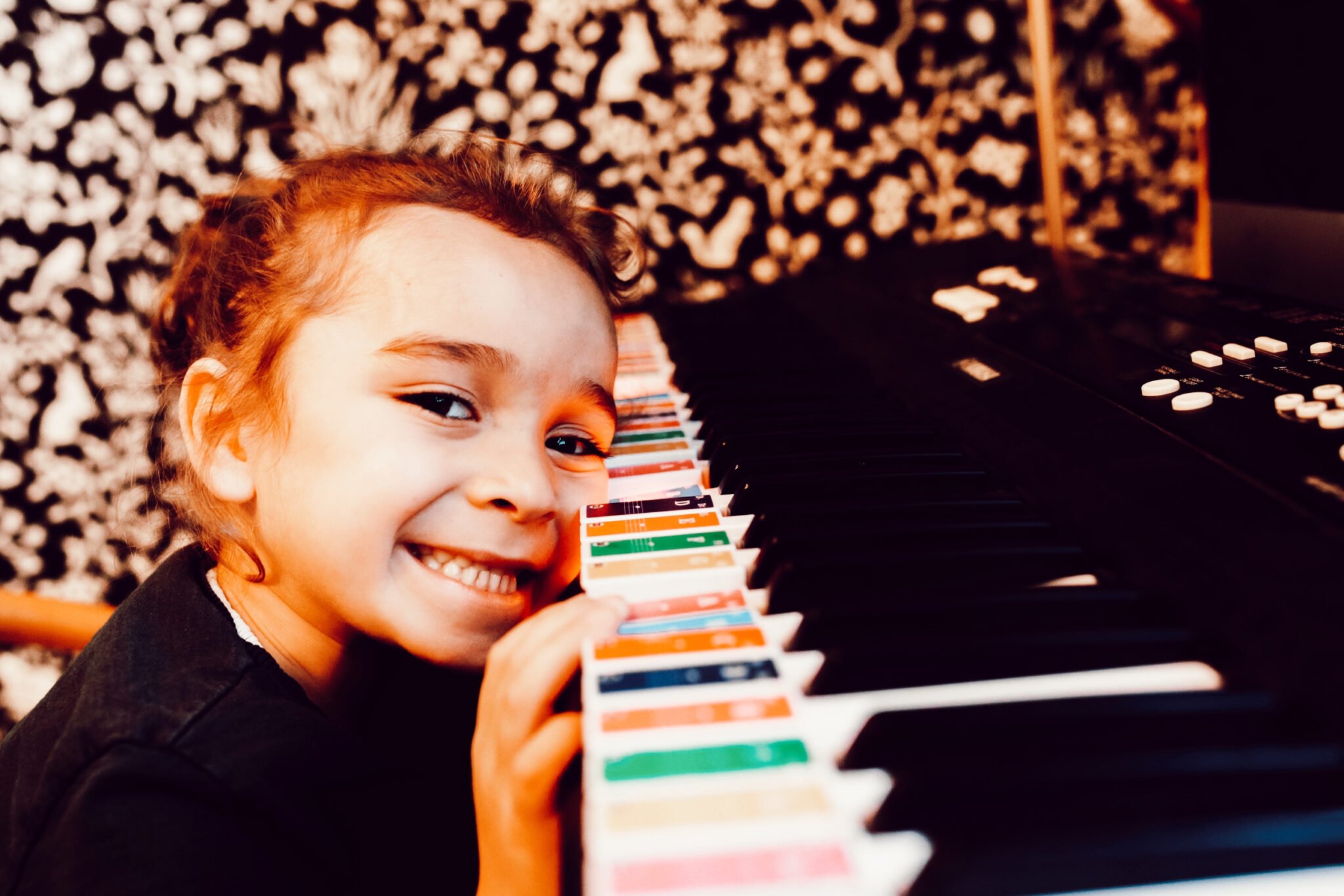 toddler leaning on piano