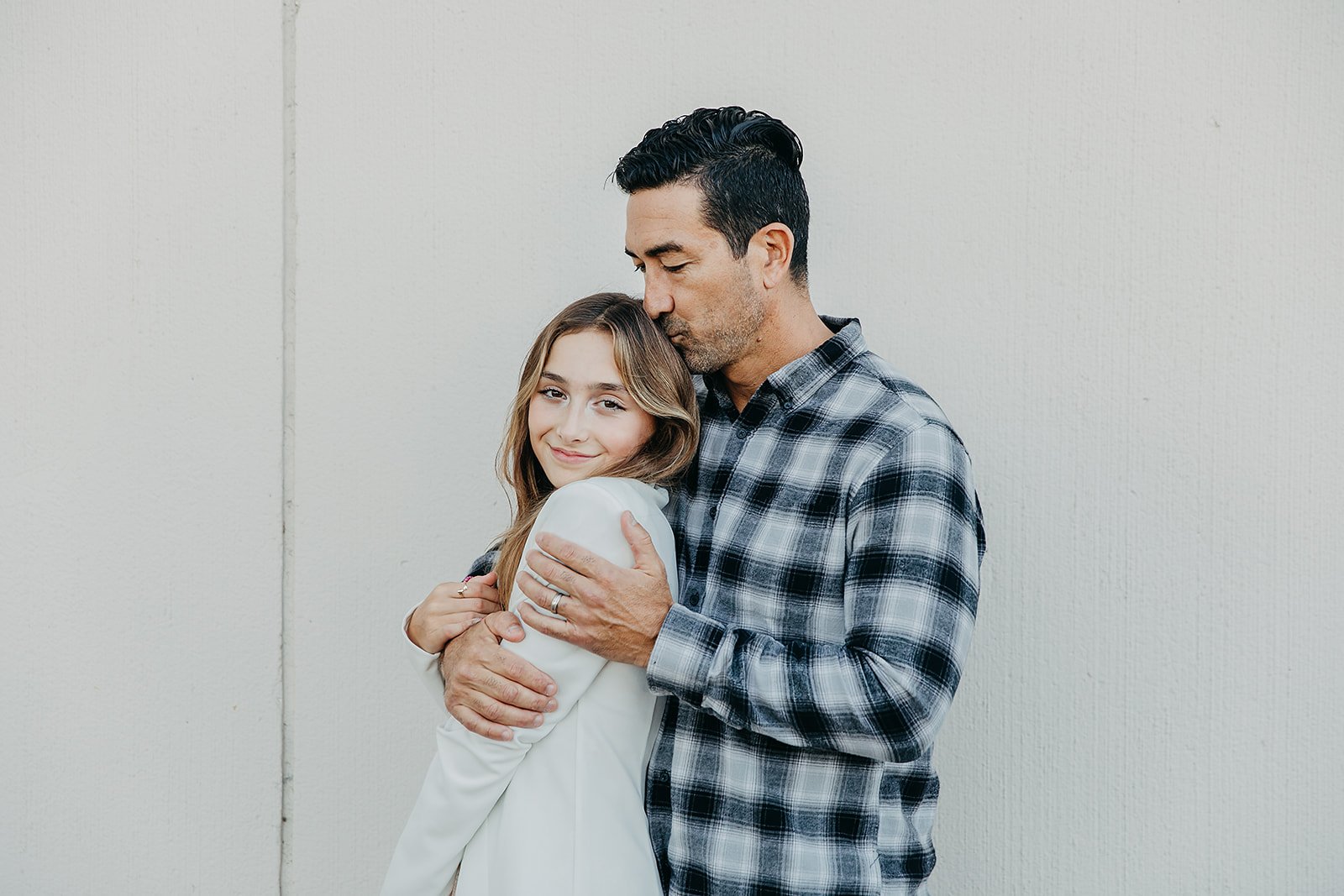 dad kissing his daughter